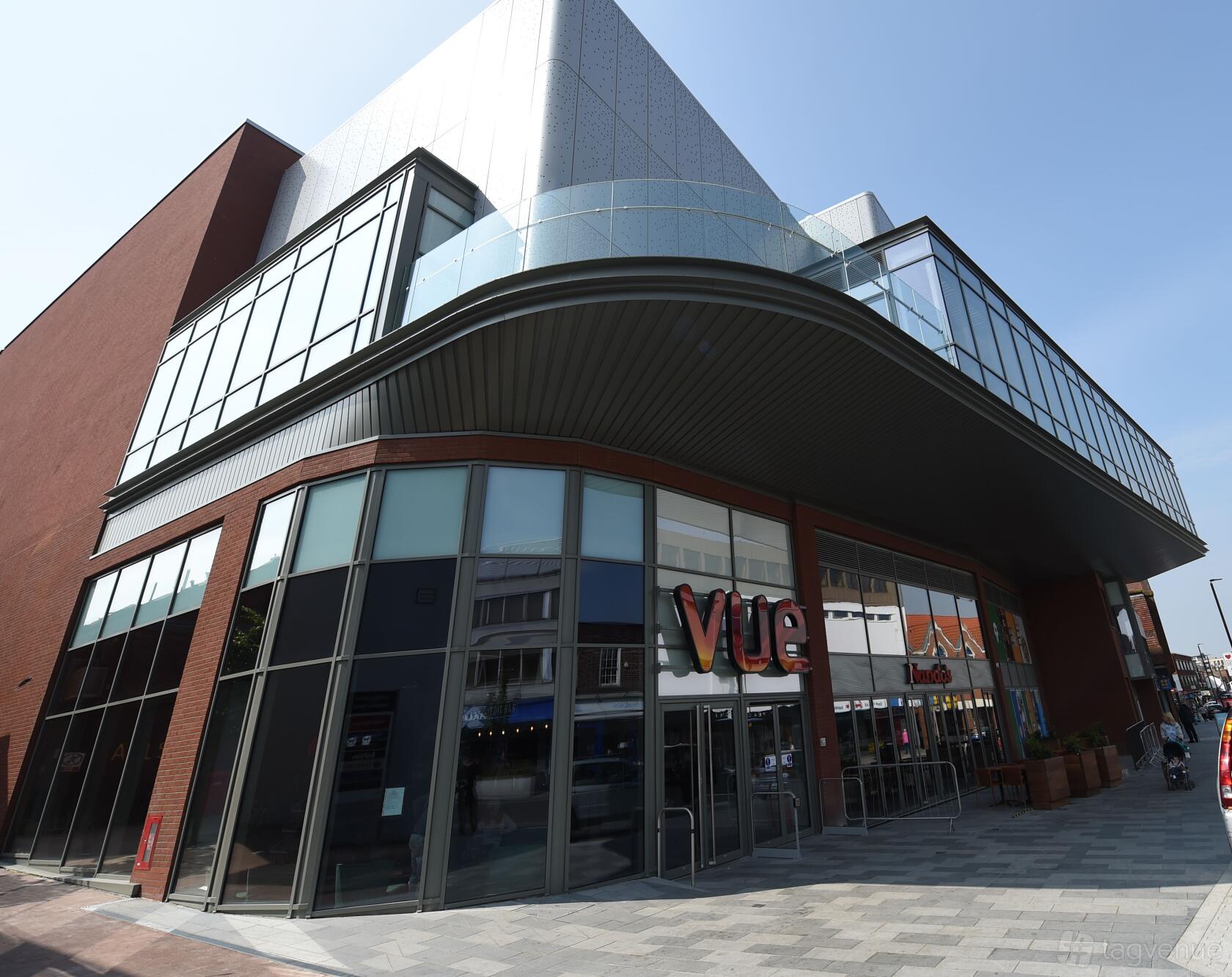 A cinema with a glass-fronted entrance, angular roof, and visible Vue signage at Vue Eltham.