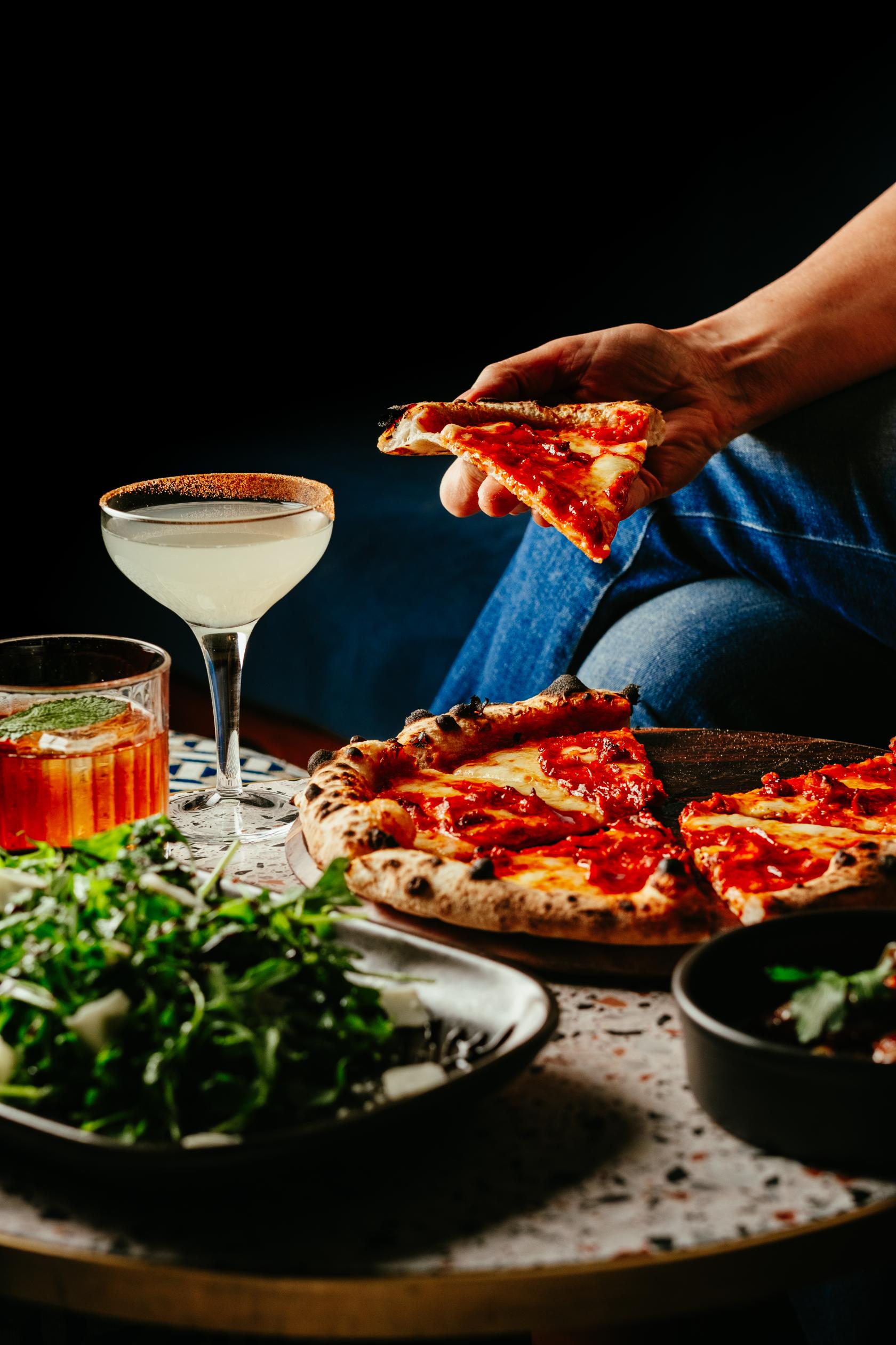 A cocktail bar setting with wood-fired pizzas, a margarita and an old fashioned at LOCKES Bar Covent Garden.