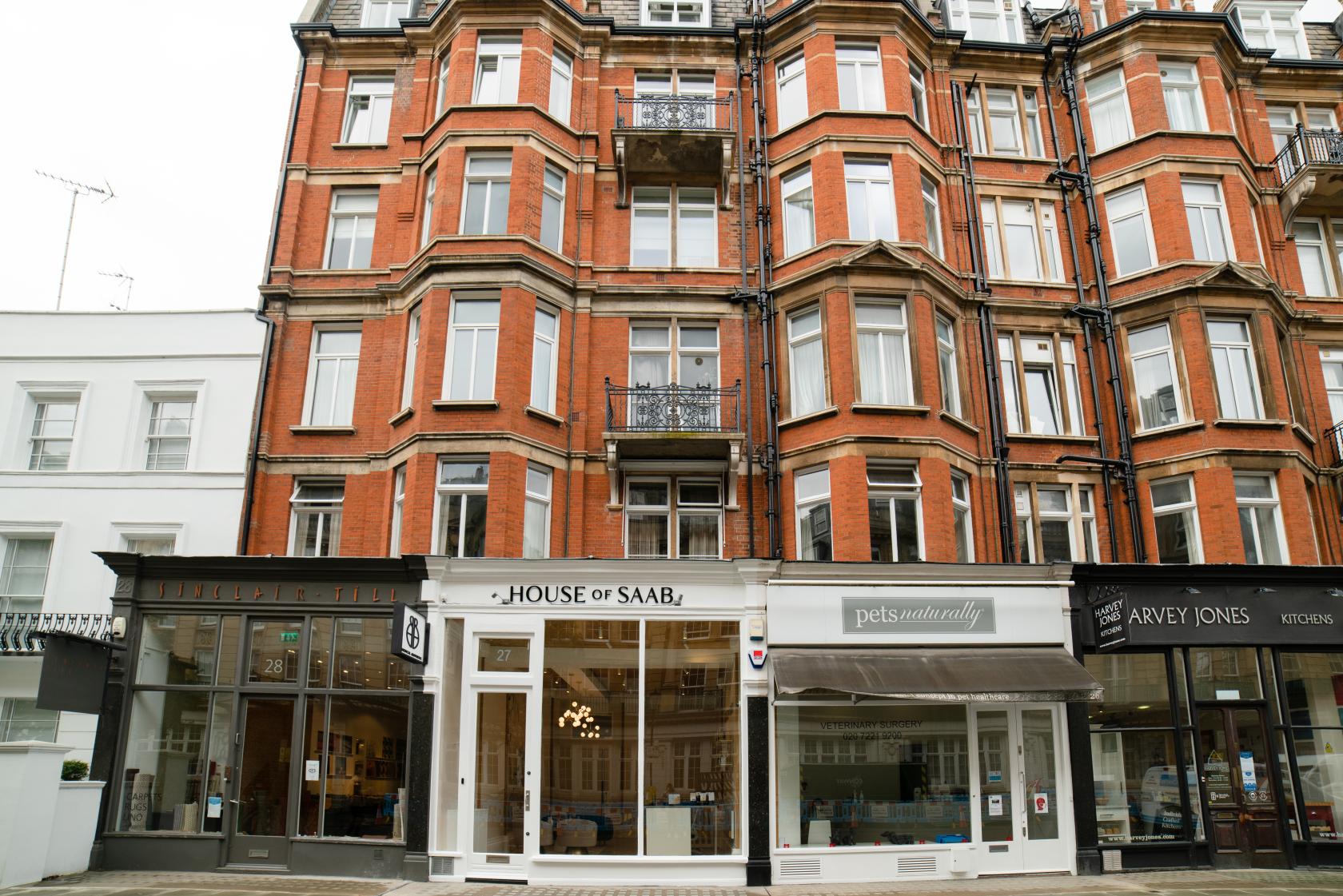 A versatile event space with a brick façade and large street-facing windows at House of Saab.