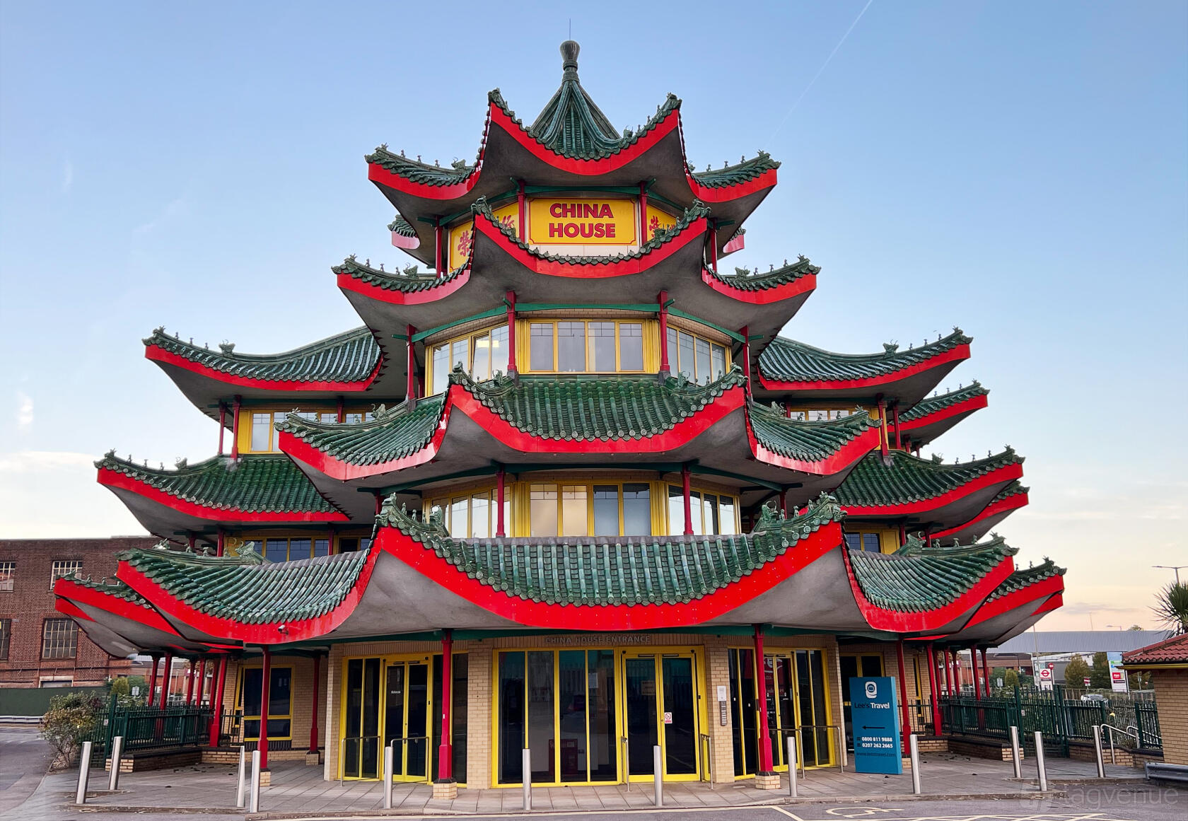 A film and photo studio with a multi-tiered pagoda façade, green tiled roofs, and vibrant red trim at Blend Studios.