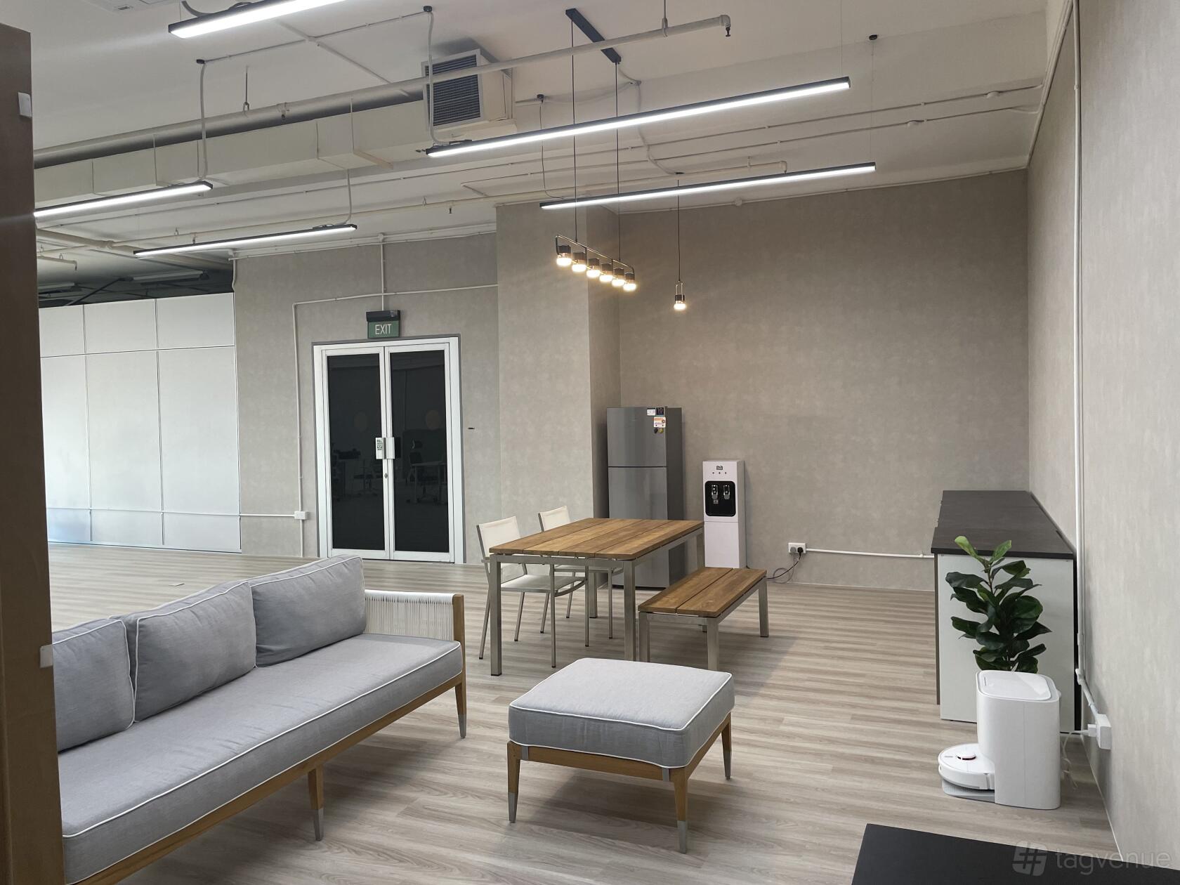A photo studio with a seating area, wooden dining table, refrigerator, and potted plant at Highly Customisable Space for Shoots/Filming.