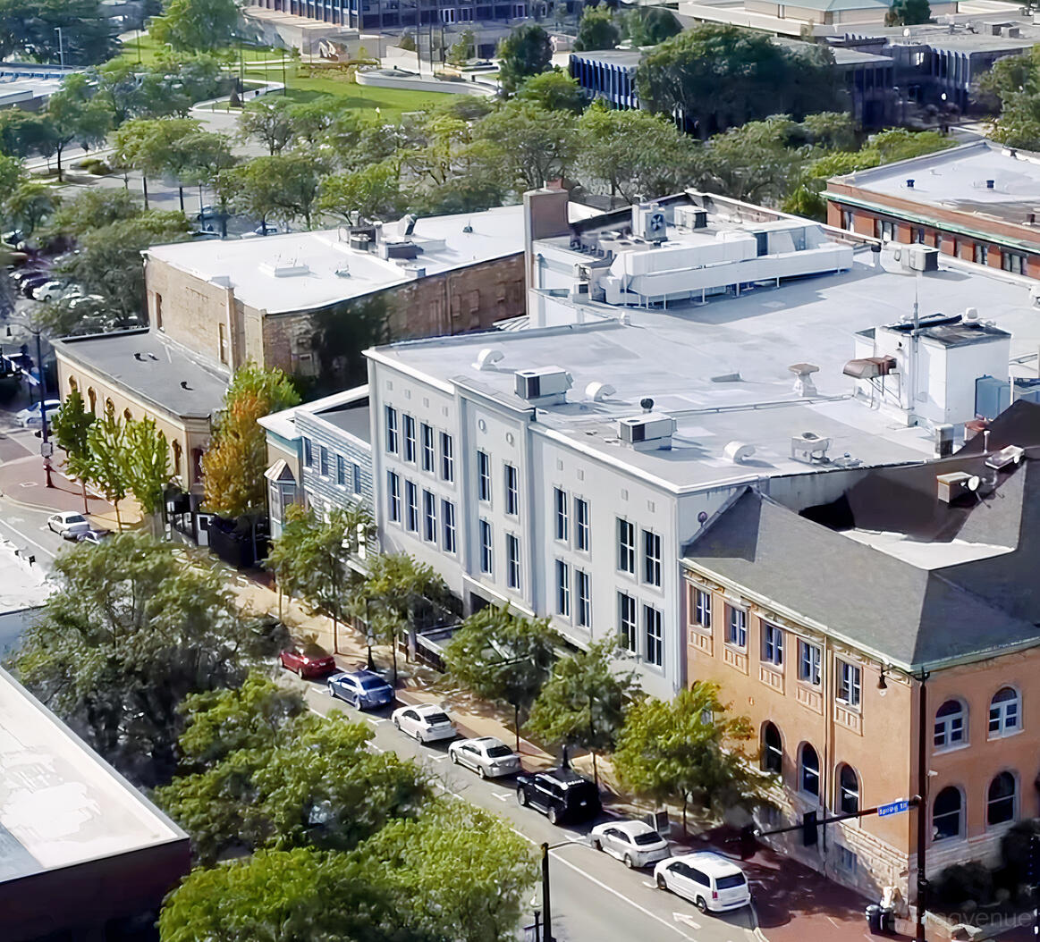 A versatile event space with a two-story industrial facade and large vertical windows at The Highland Loft.