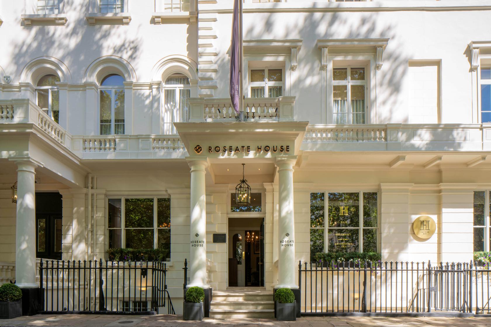 A restaurant with a grand white facade, tall columns, and large windows at The Hyde Restaurant & Bar.