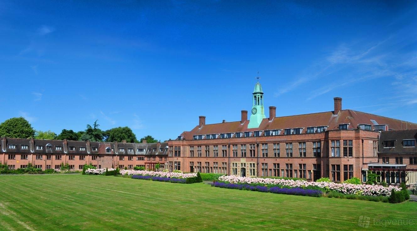 An academic venue with a large red-brick building, clock tower, and landscaped lawn at Liverpool Hope University - Hope Park.
