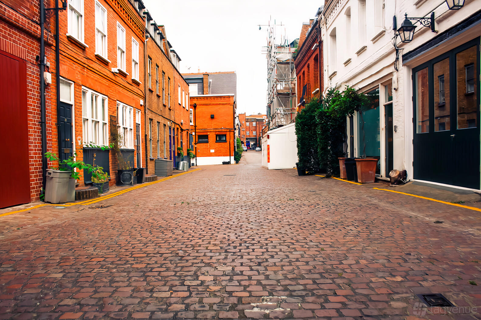 A versatile event space with exposed brick buildings and a cobblestone courtyard at Kensington, Iverna Gardens.