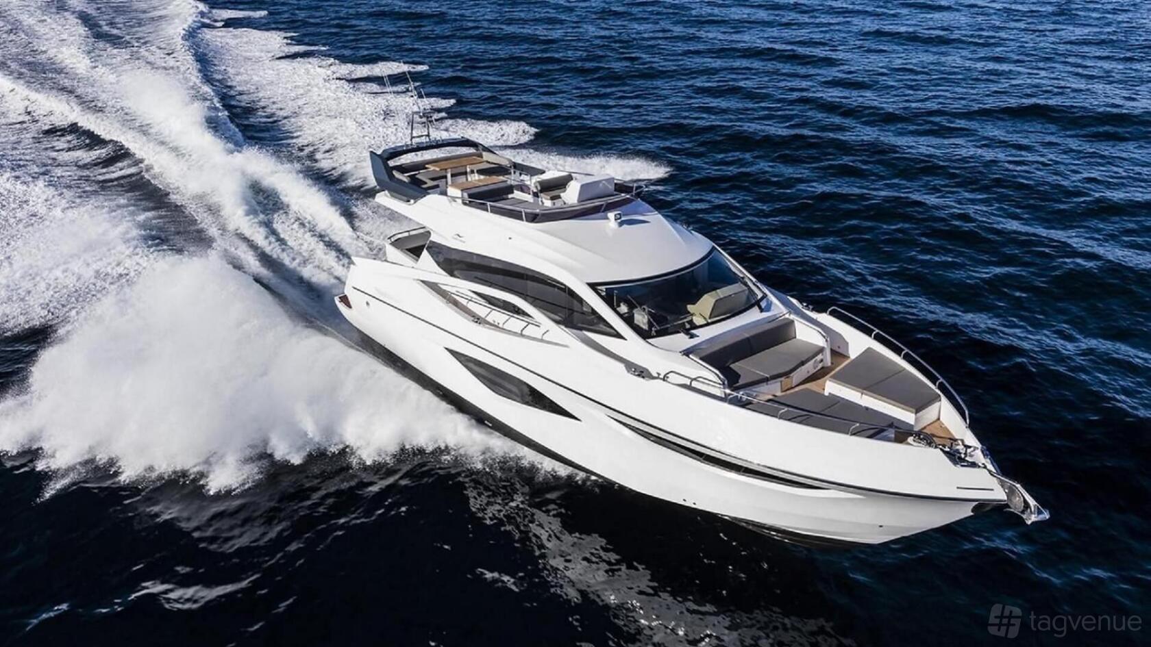 A luxury yacht with multiple outdoor seating areas cruising on open water at Pearl Yacht Charters.
