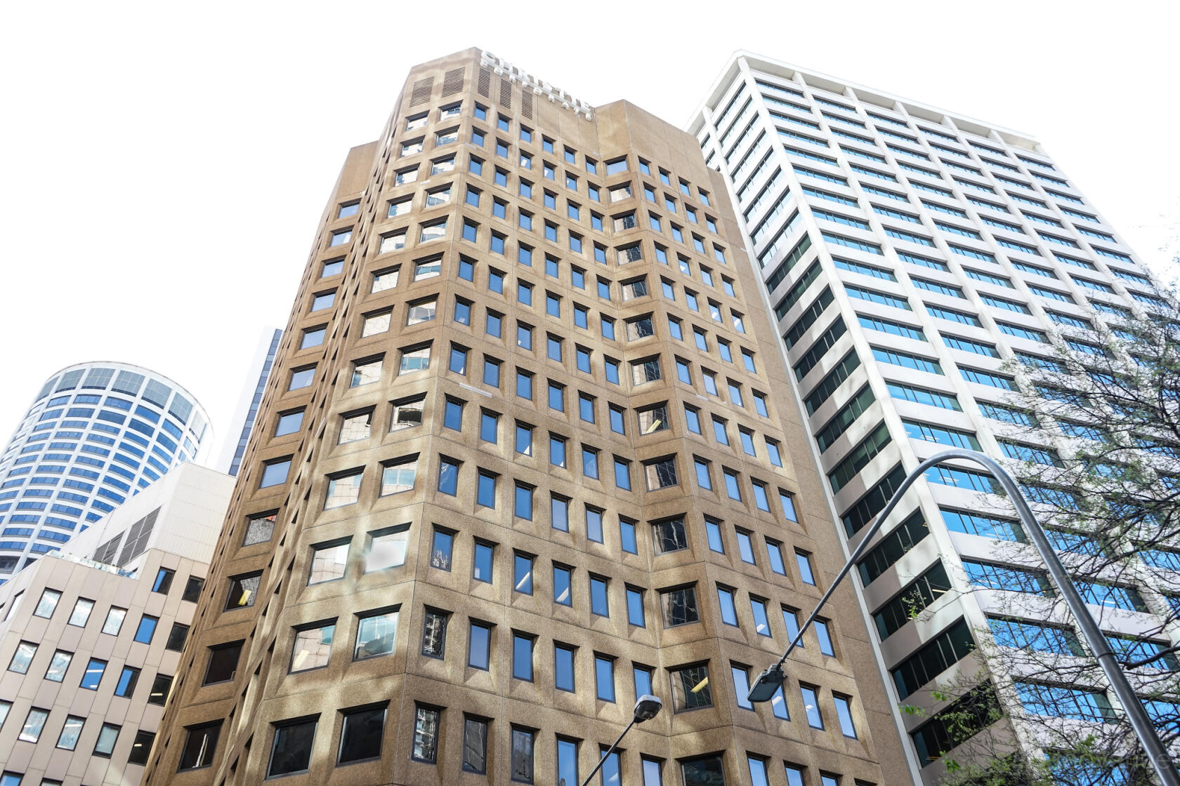 A coworking space in a tall brown office building with grid-patterned windows at Christie Spaces Spring Street.