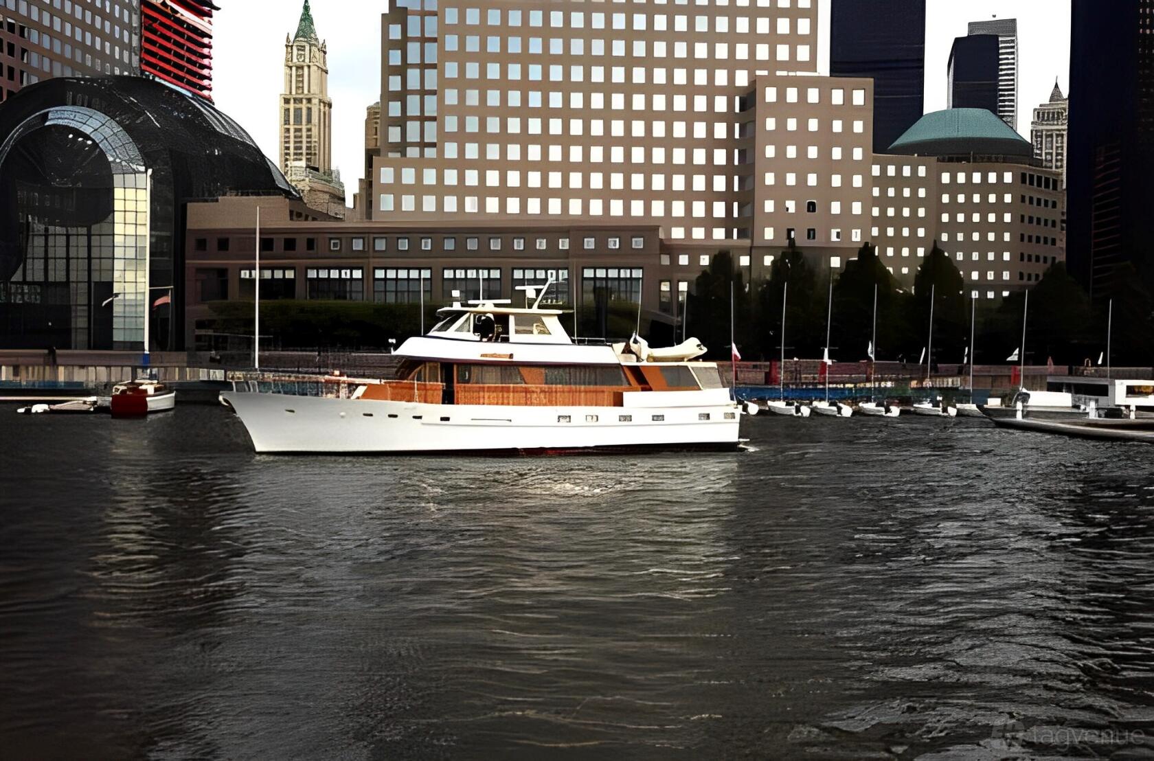 A classic yacht with wood paneling and open upper deck docked at Chelsea Piers Marina