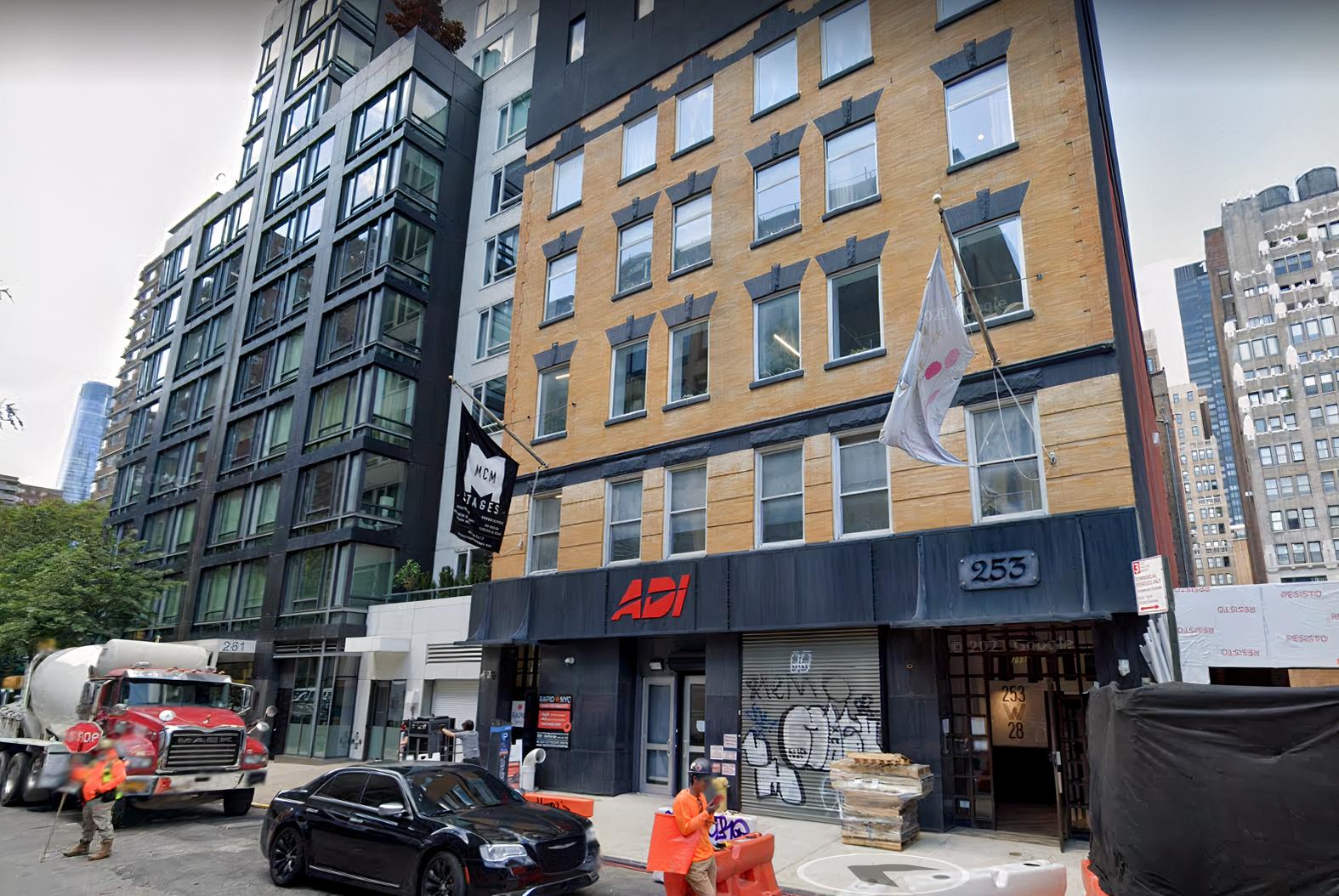 A recording studio building with a brick and black facade, street-level entrance, and large windows at MCM Stages.