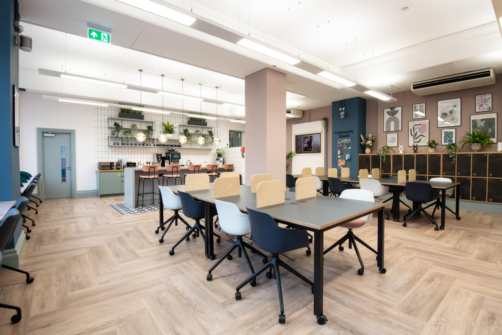 A coworking space with shared desks, ergonomic chairs, and plants at Wizu Workspace - Leeds - Leeming Building.