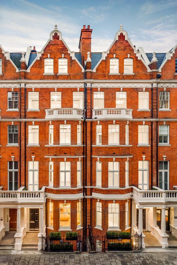 A conference centre with a red brick exterior, tall sash windows, and decorative white stone trim at Landmark: Park Street, Mayfair, London.