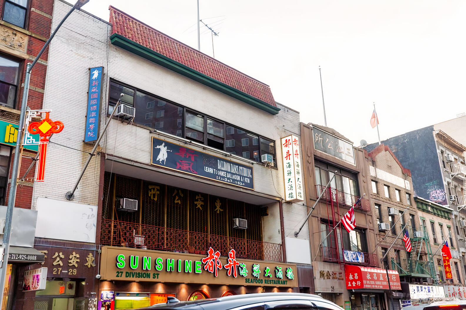 A city street view with restaurant signage and building facades at Imperial Ballroom.