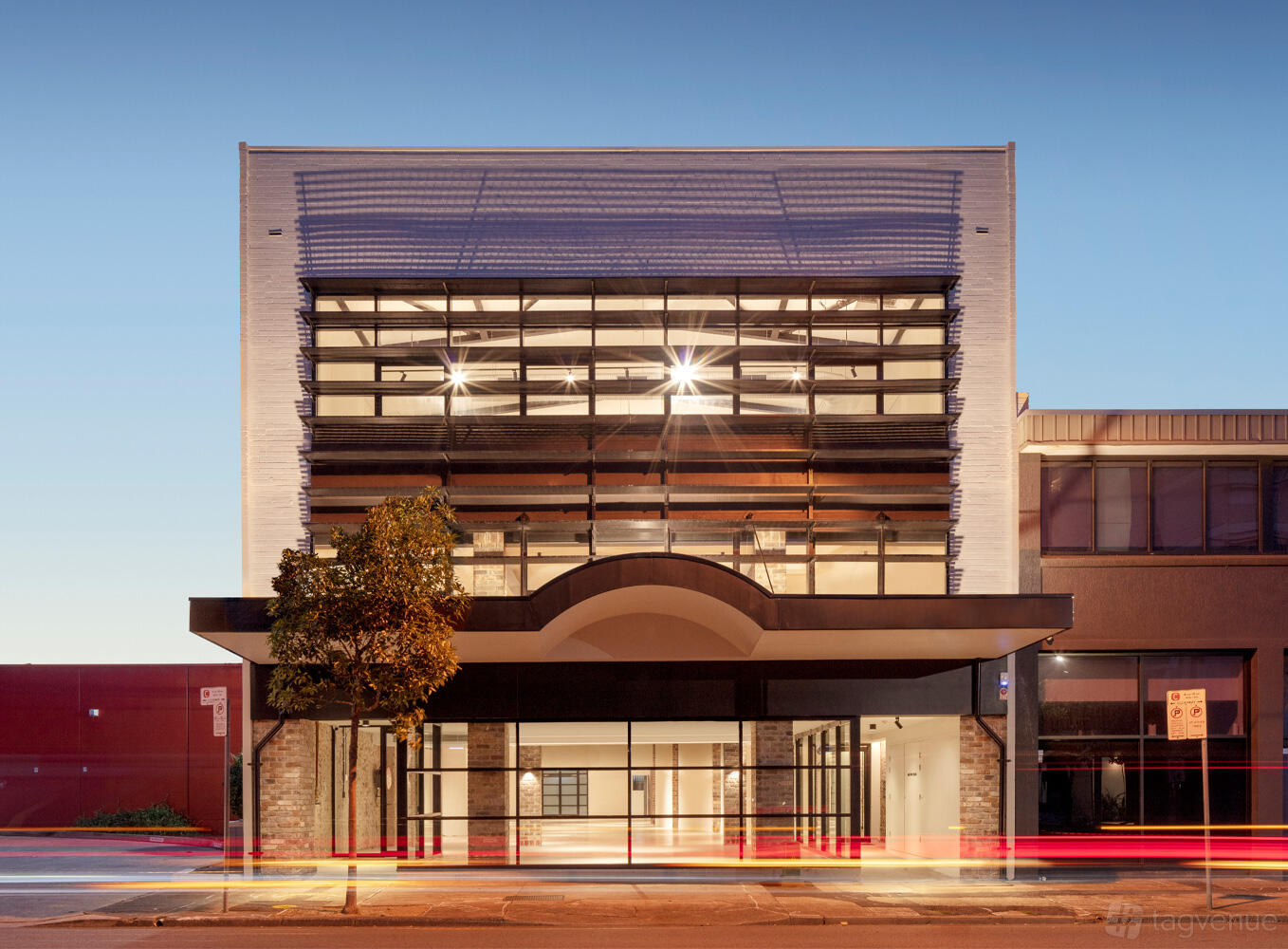 A versatile event space with a glass facade, exposed brick accents, and wide streetfront windows at Sydney Showroom.