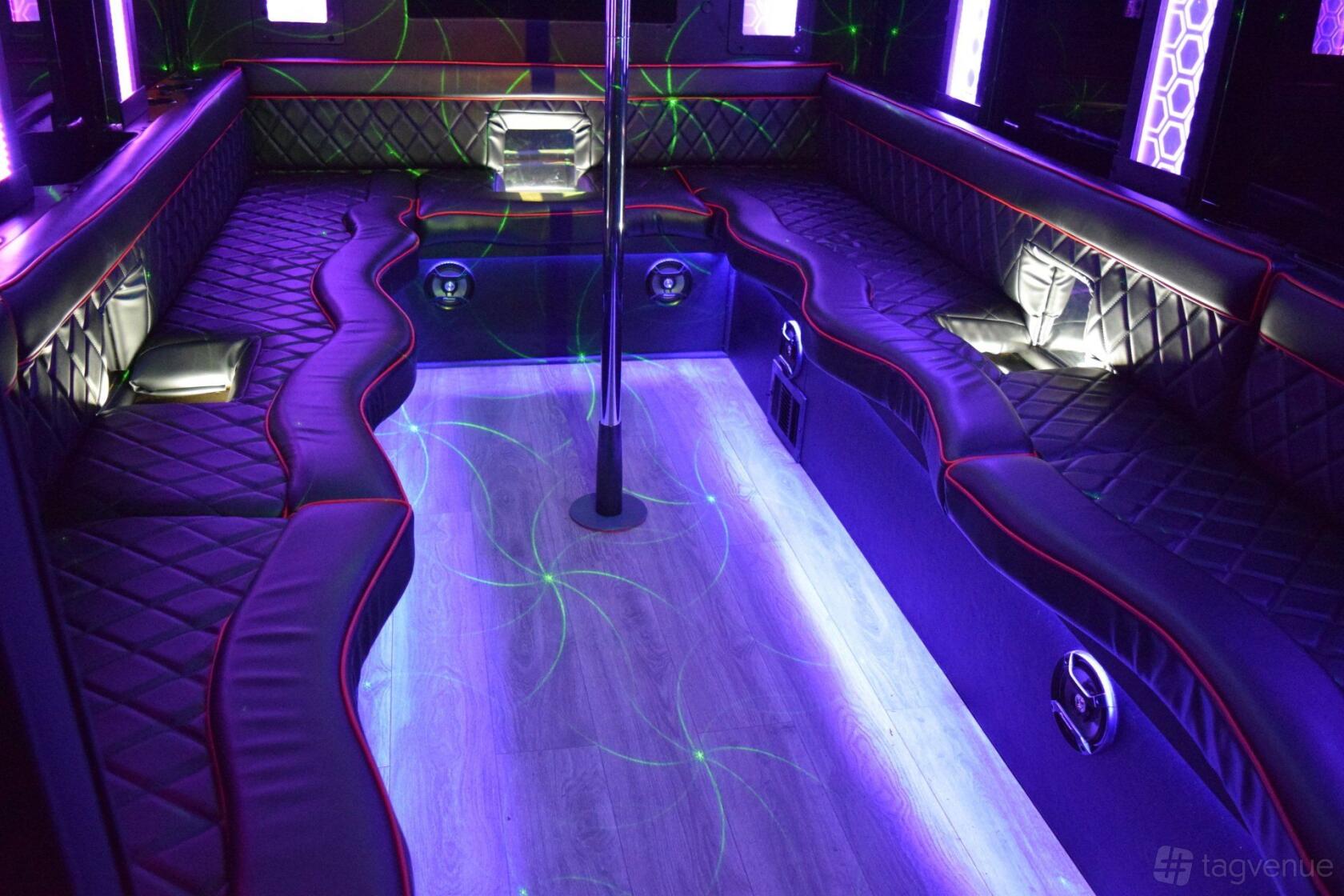 A party bus with wraparound leather seating, LED lighting, and a dance pole at GOGO Party Bus.