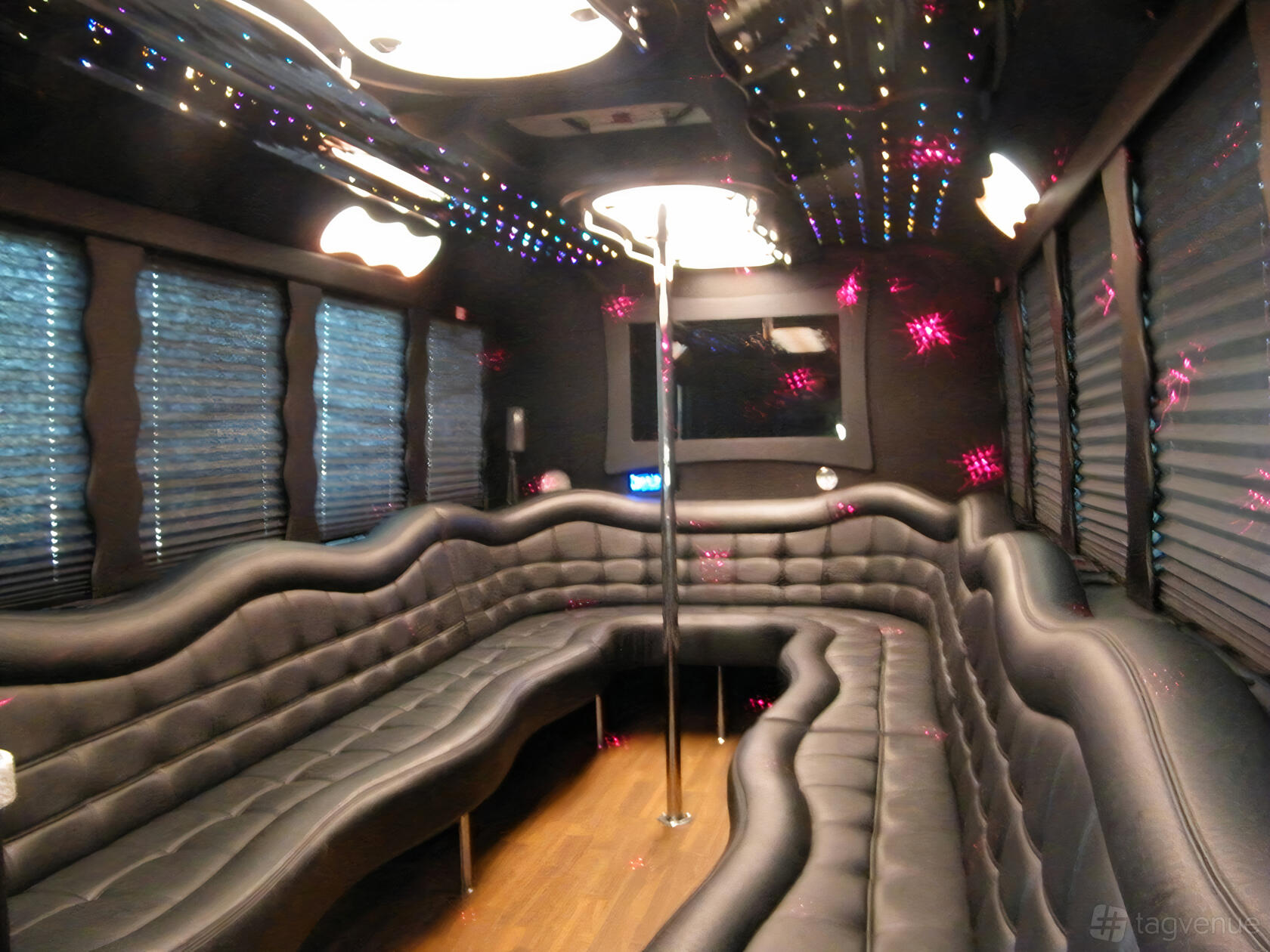 A party bus with wraparound leather seating, mirrored ceiling panels, and colorful LED lighting at Mermaid Luxury Limo Mississagua.