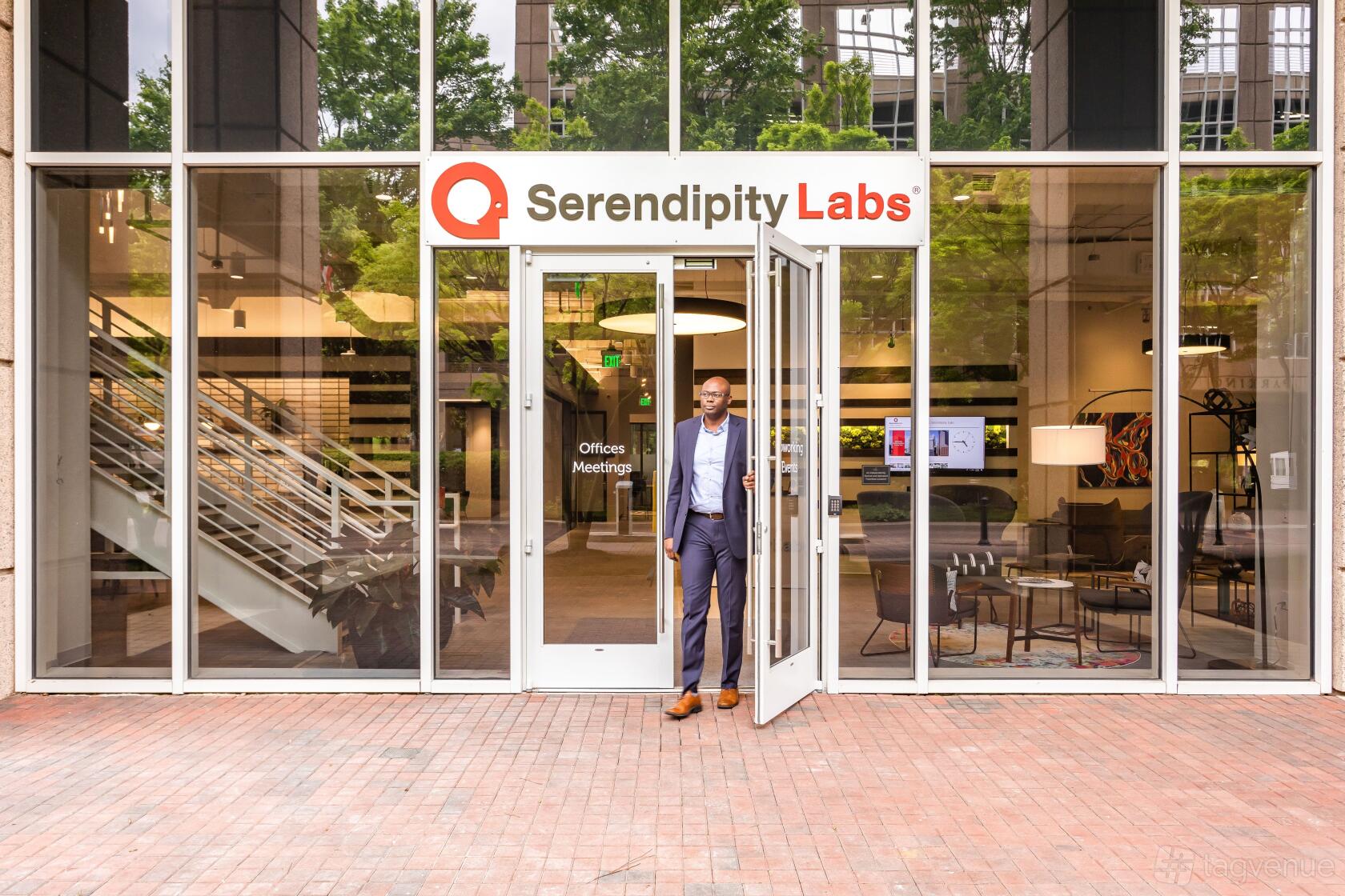 A meeting centre with floor-to-ceiling glass windows, prominent signage, and a modern entryway at Serendipity Labs Atlanta – Cumberland Vinings.