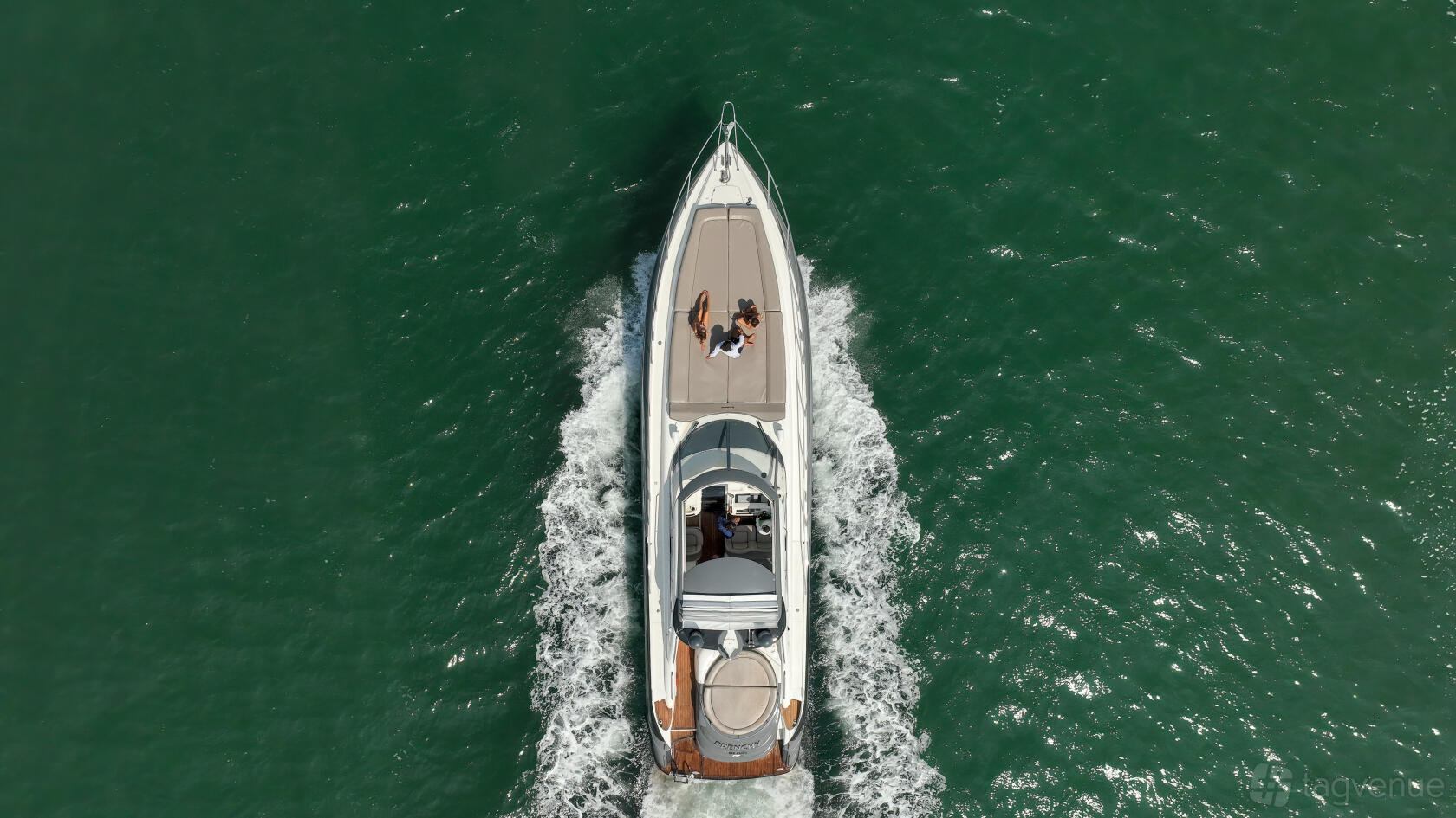 A white boat with an open sun deck cruising on green water at Eco Boats.