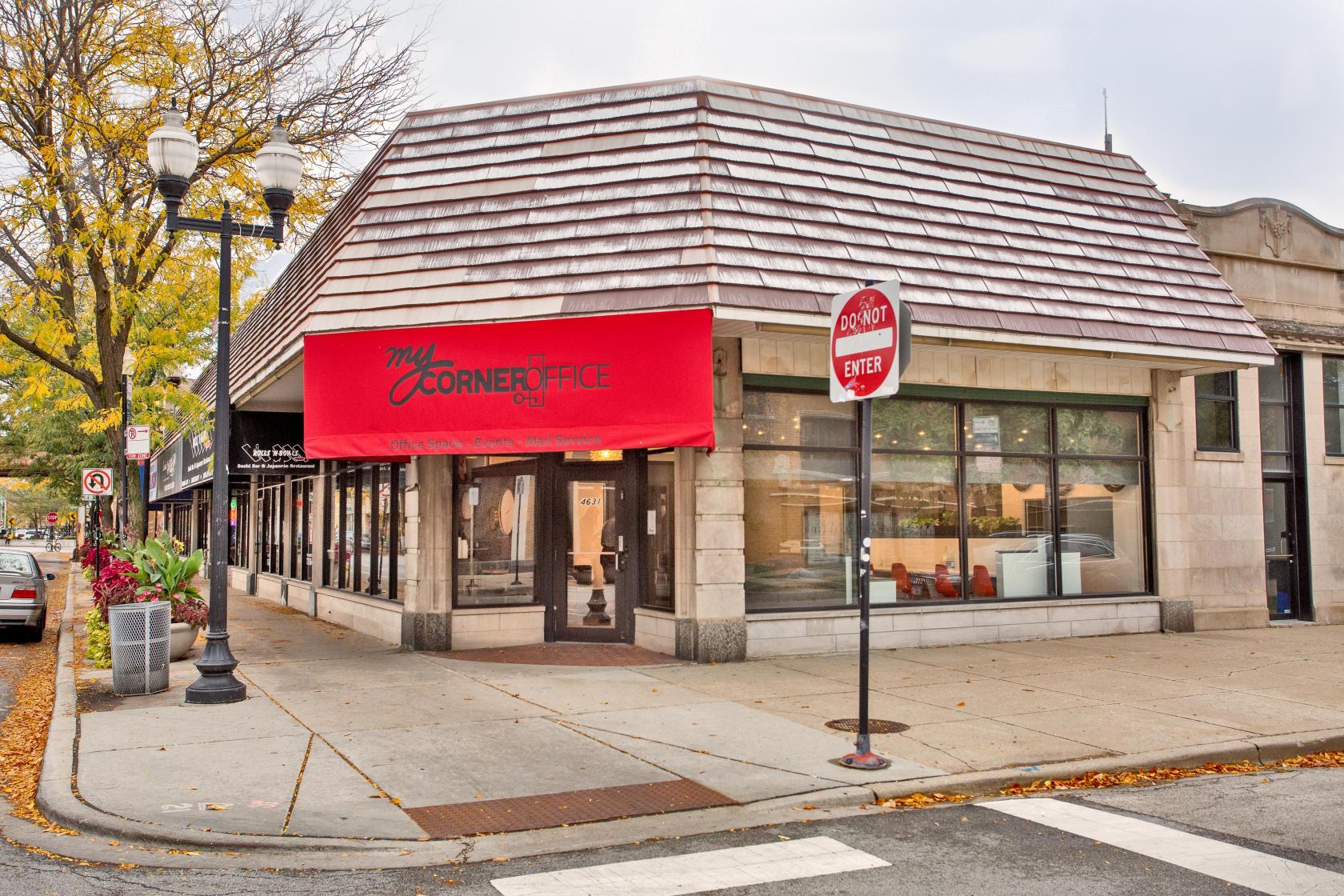 A coworking space with a red awning and large front windows at My Corner Office.