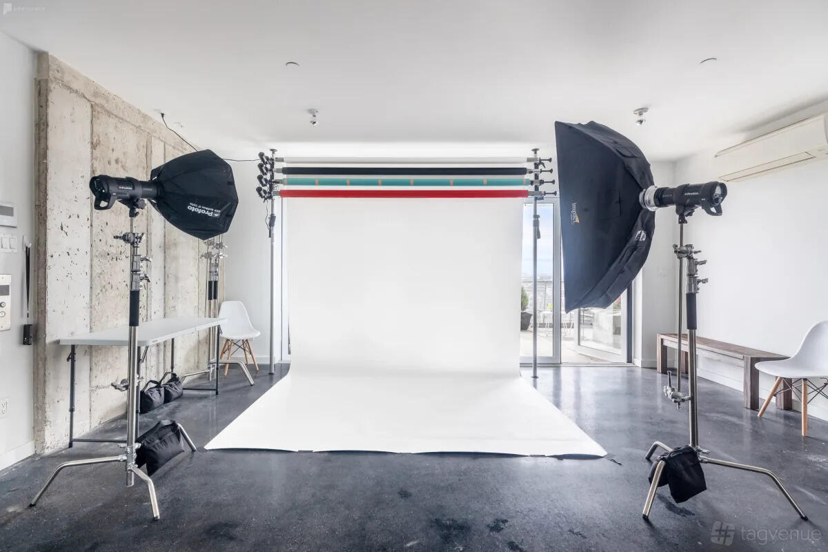A photo studio with seamless paper backdrops, softbox lights, and polished concrete floors at Oasis Labs Brooklyn.