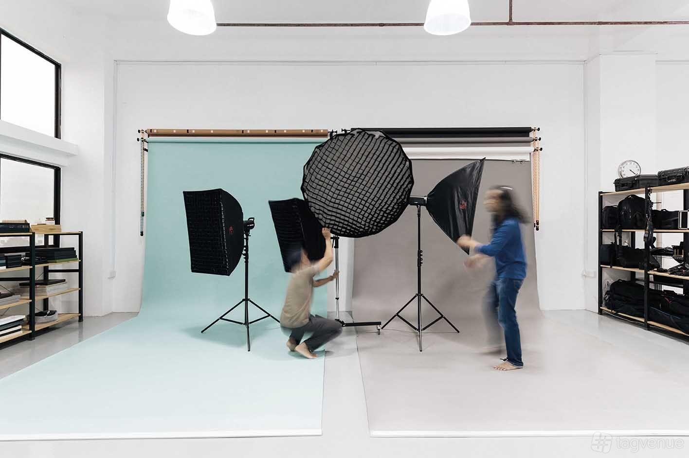 A photo and film studio with seamless backdrops, softbox lighting, and open shelving at Reelwerkz.
