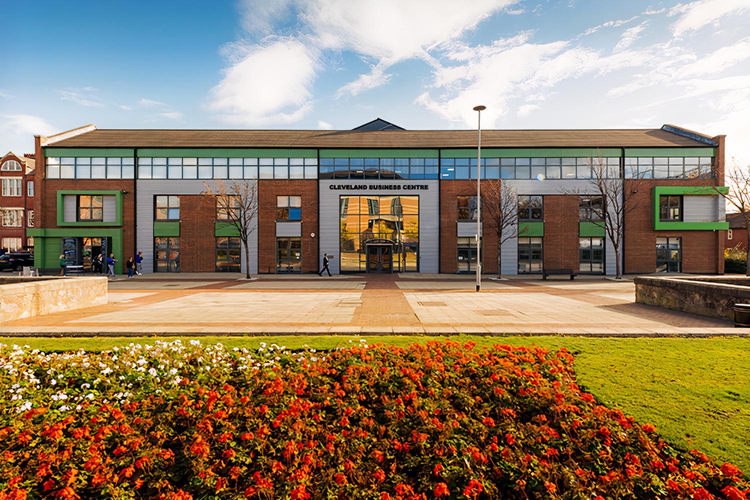 A conference centre with a brick façade, large windows, and landscaped gardens at Biz Hub Middlesbrough.