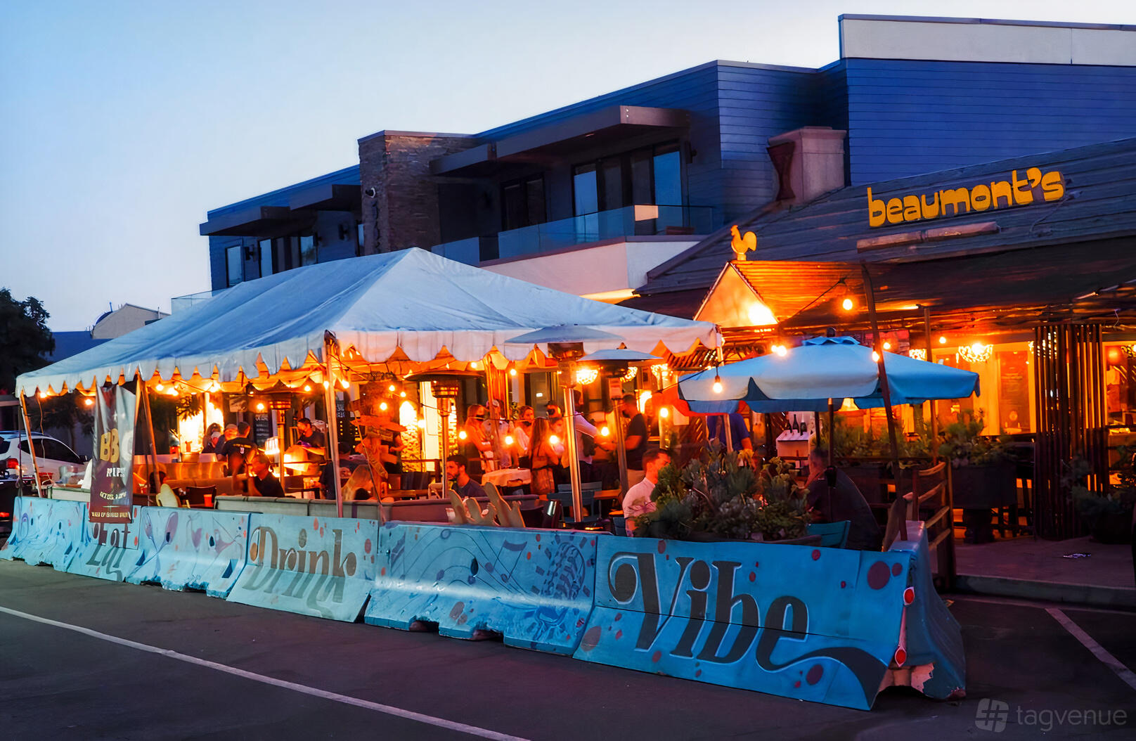A restaurant with a covered outdoor patio, string lights, and evening ambiance at Beaumont's.