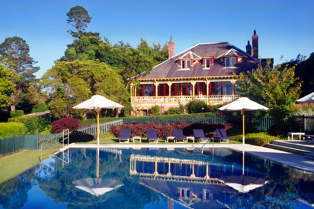 A hotel with a landscaped garden, outdoor pool, sun loungers, and a colonial-style building at Lilianfels Resort & Spa.
