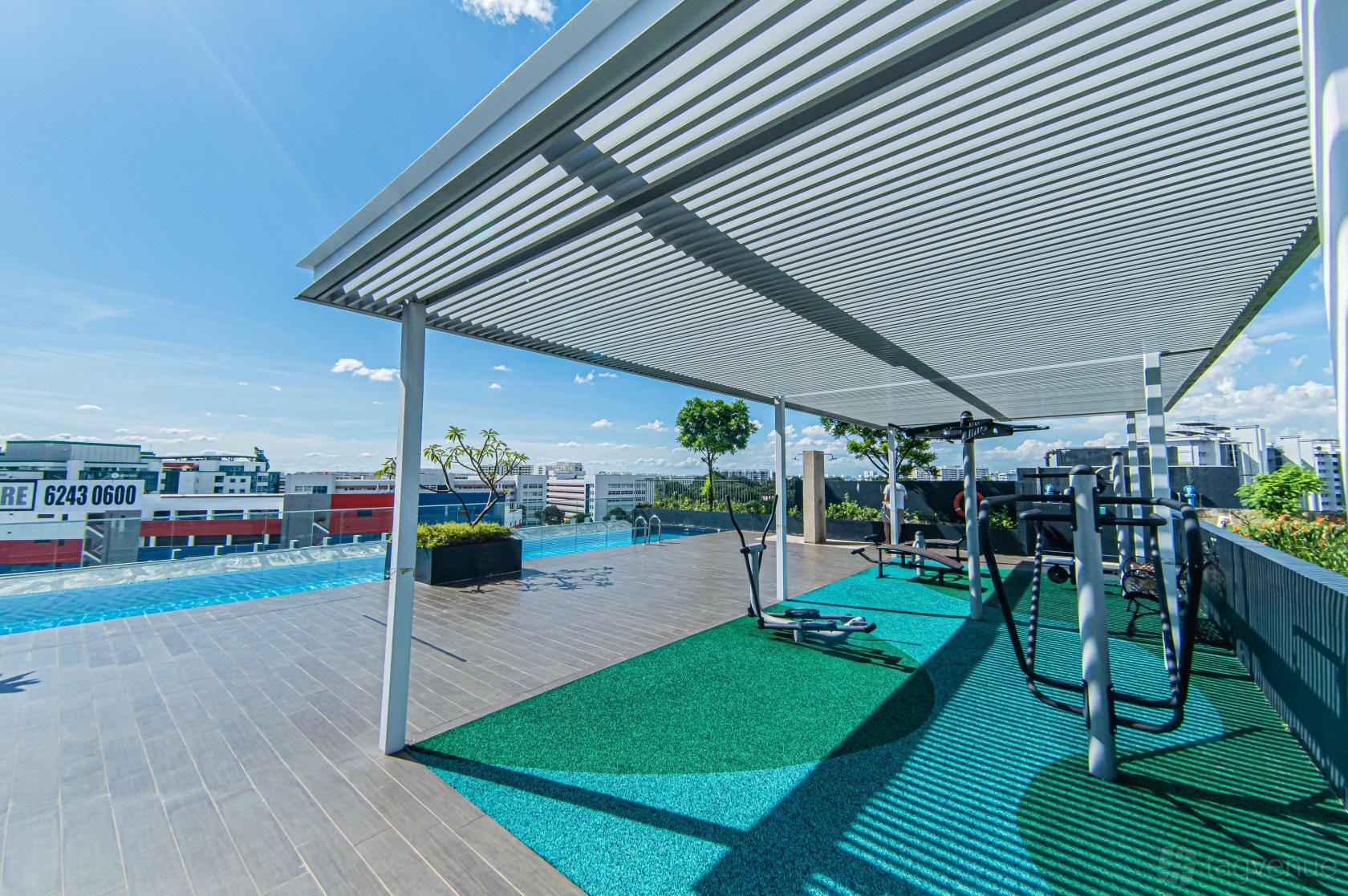 A rooftop with an outdoor pool, exercise equipment, and a shaded pergola at Stal Pte Ltd.