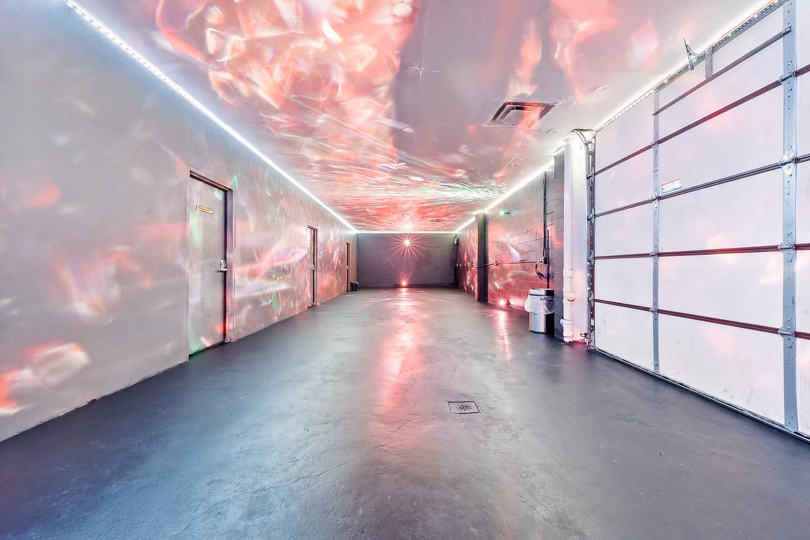 An event venue with reflective lighting effects and polished concrete floors at Oxford Studios