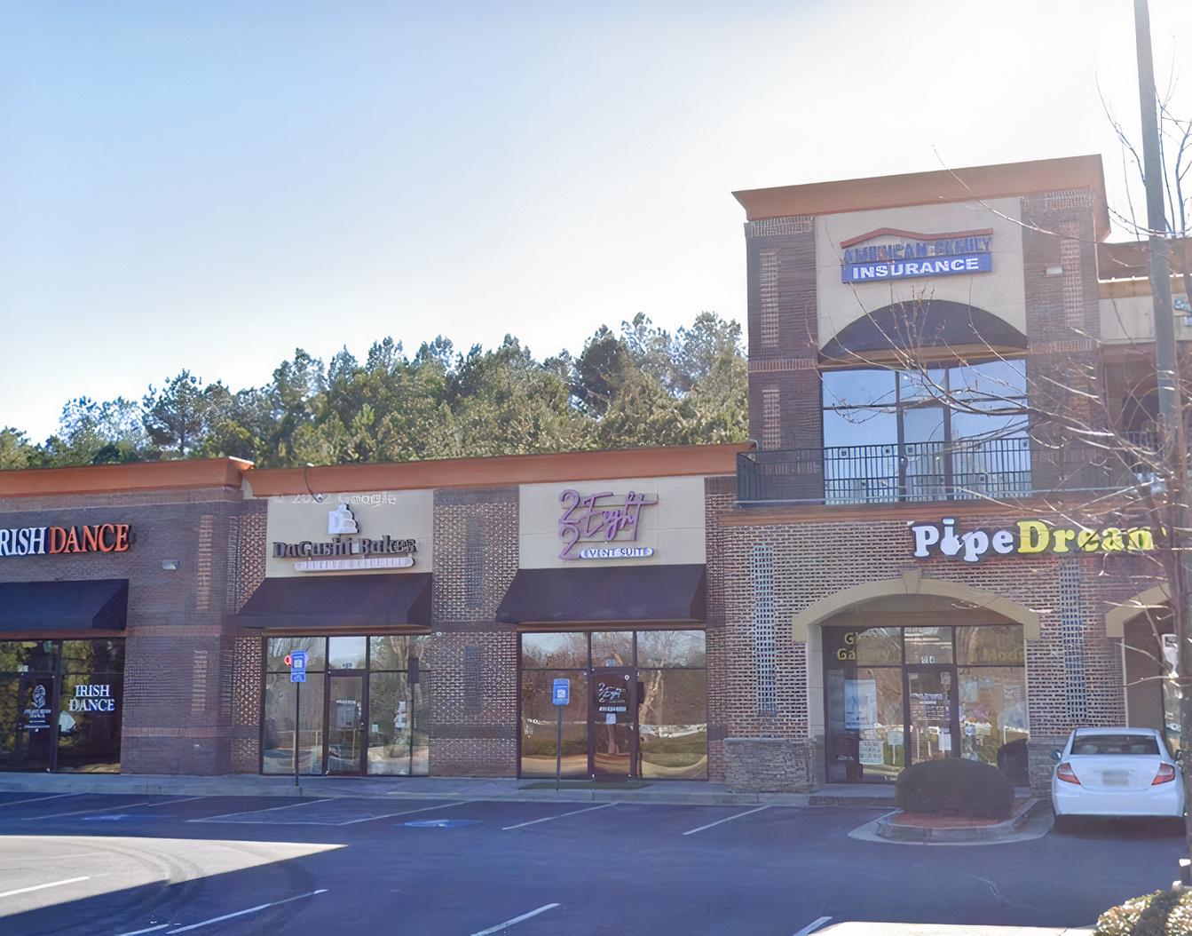 A versatile event space located in a brick commercial building with large windows at 22Eight Event Suite.