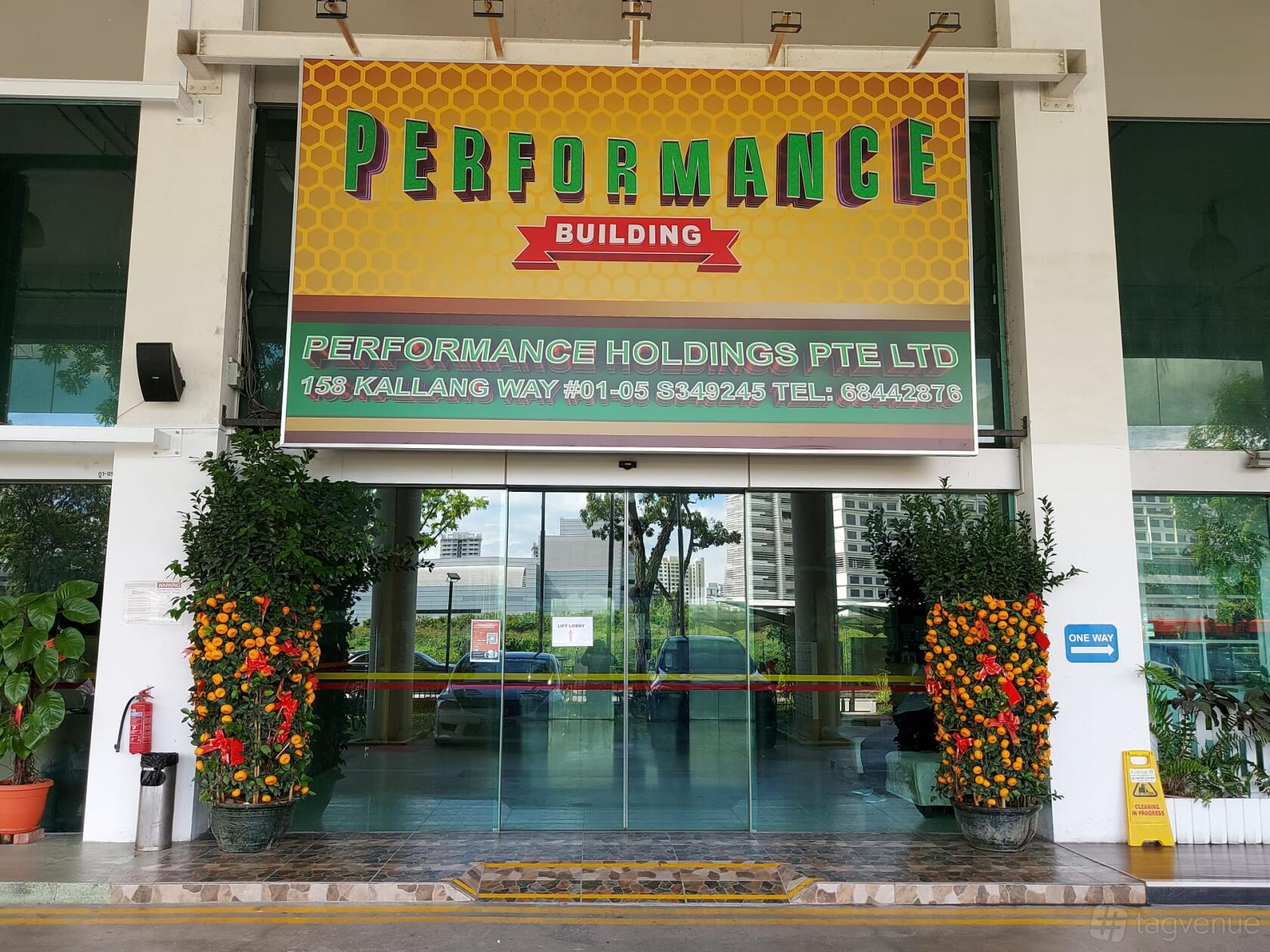 A film and photo studio with glass entrance doors, potted plants, and a colorful marquee at Performance Studios.
