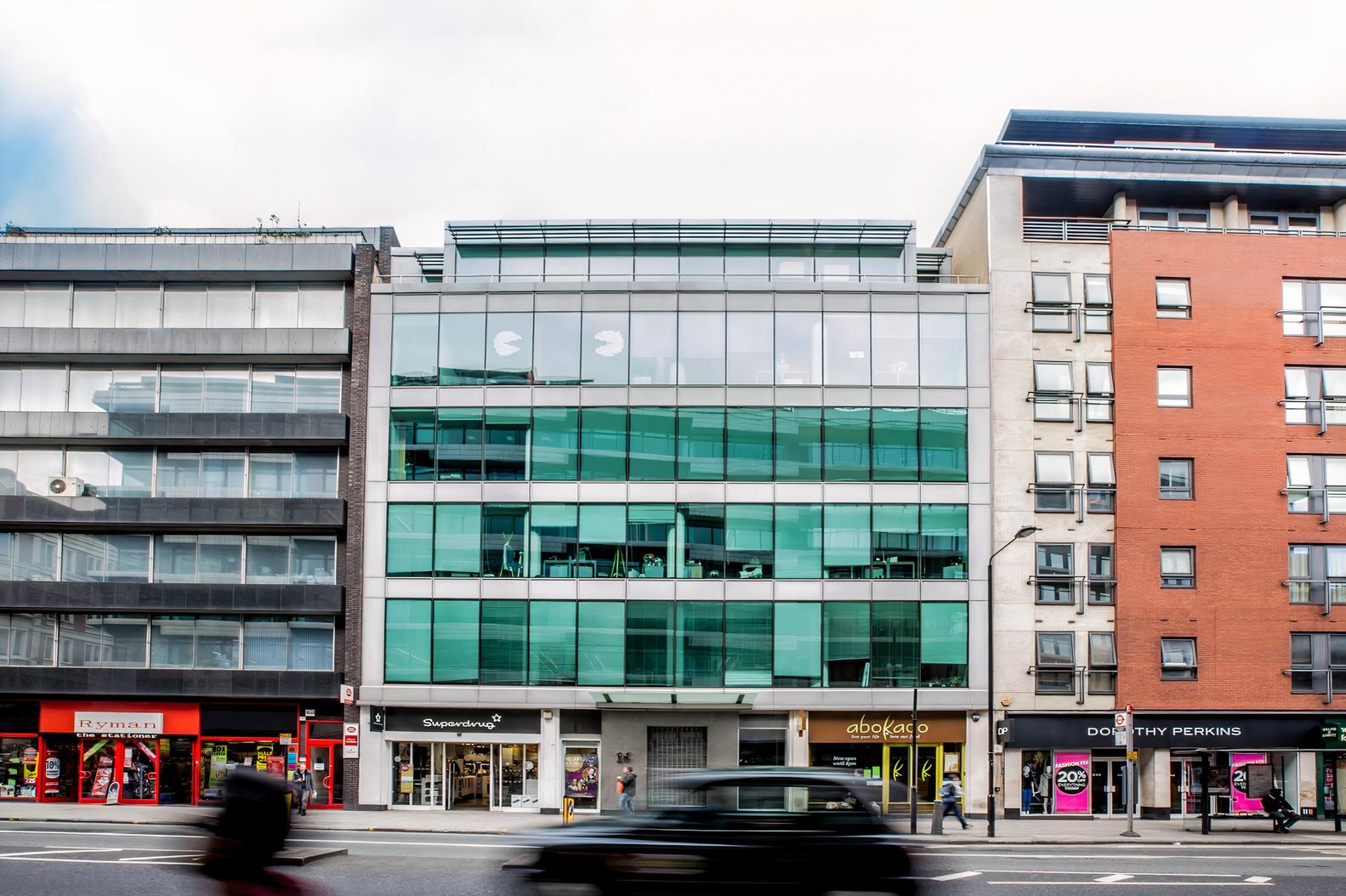 A meeting centre with a glass facade and street-level retail shops at Orega High Holborn.