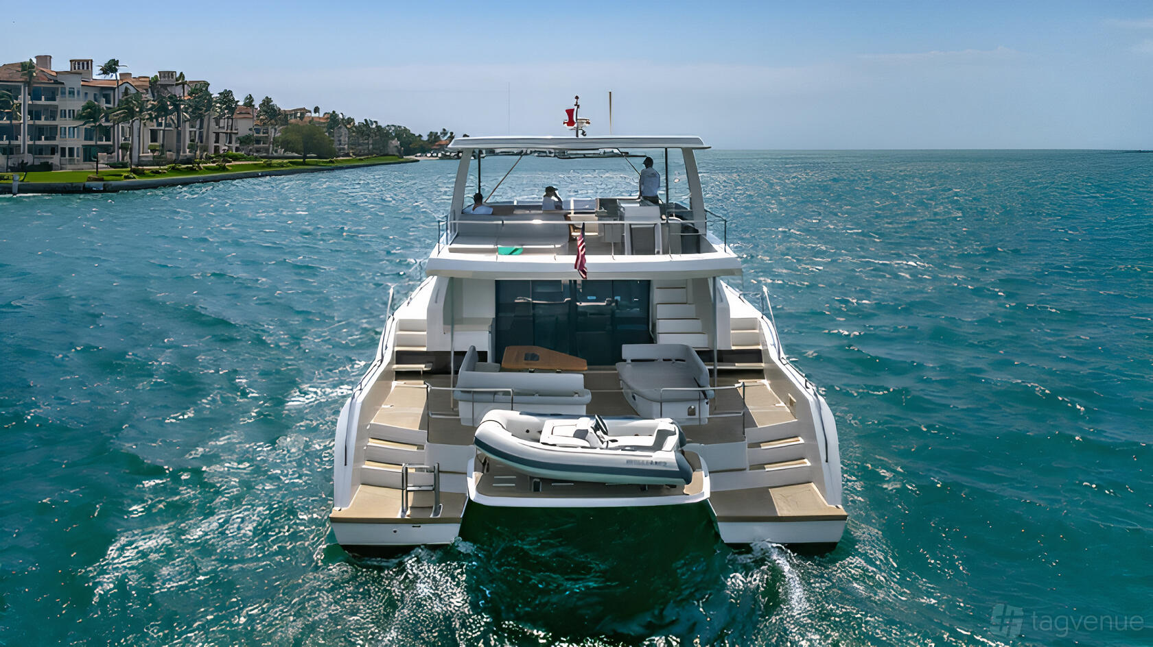 A charter boat with open deck seating, sun loungers, and a small inflatable tender at Terrific Boat Charters.