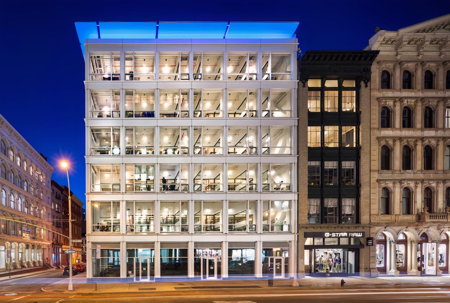 A meeting centre with a glass facade and illuminated multi-story offices at Cubico Offices.