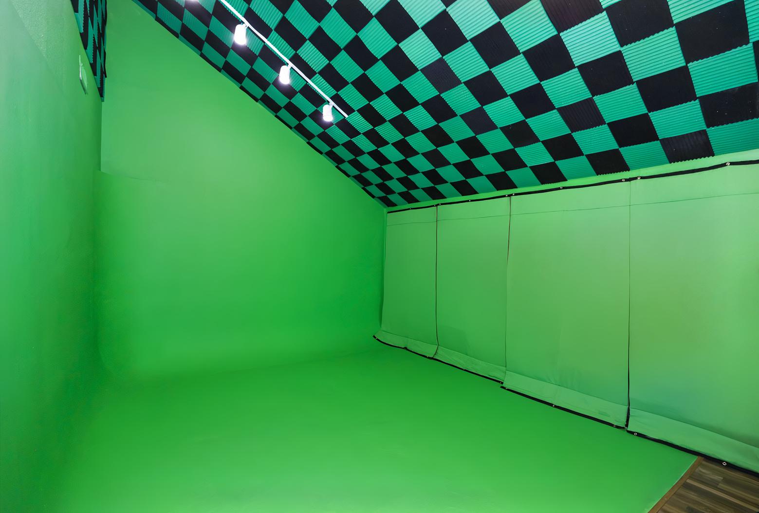 A film studio with a soundproof green cyclorama wall and a checkered acoustic ceiling at Rocky Mountain Photography Studios.