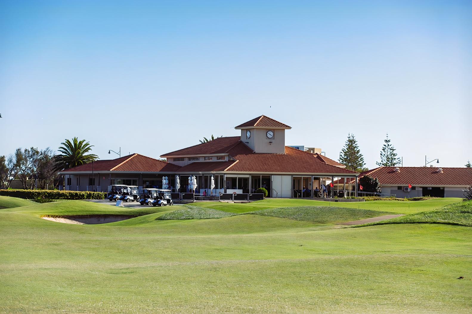 A versatile event space with a red-tiled roof clubhouse, clock tower, and outdoor terrace at Secret Harbour Golf Links.