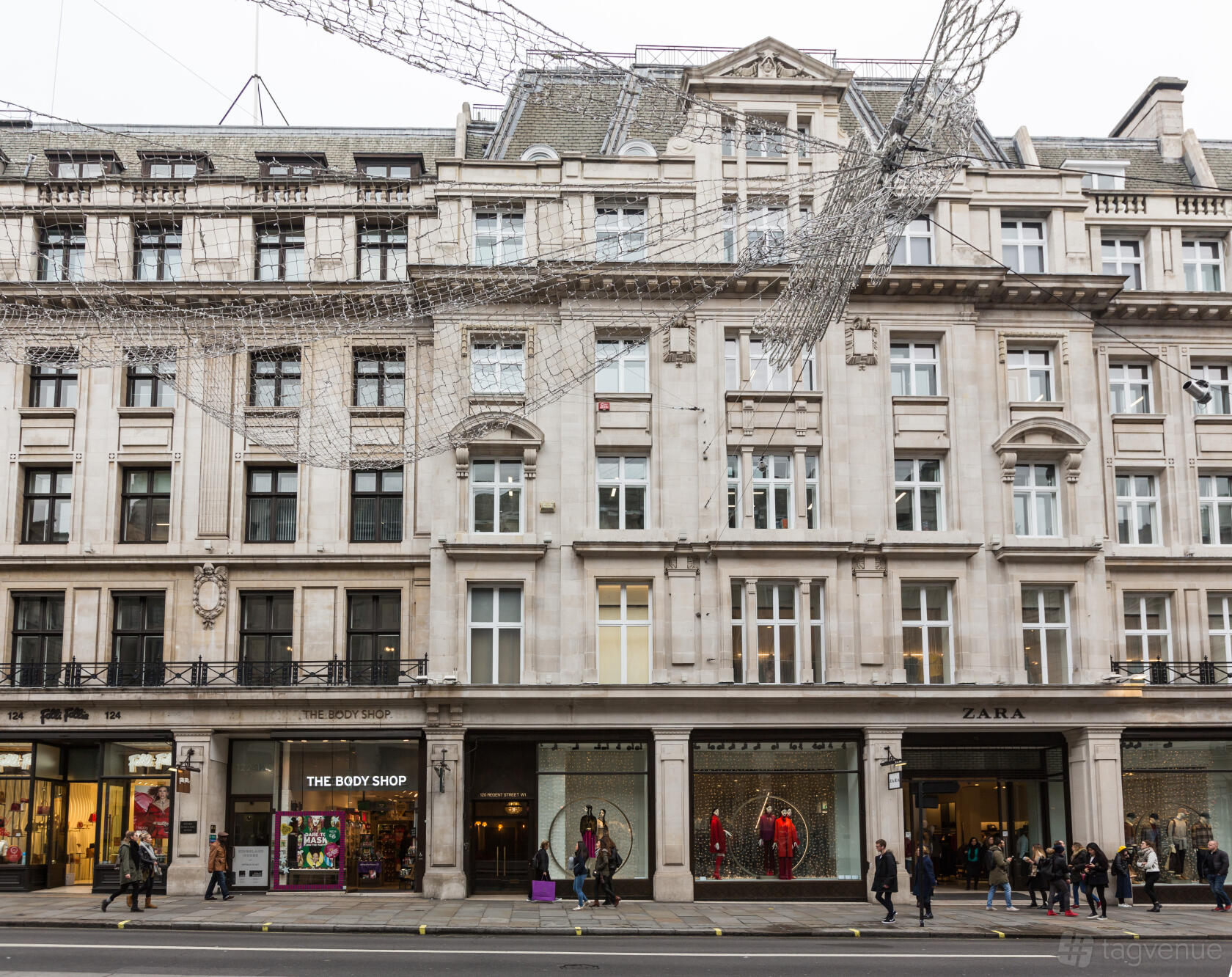 A meeting centre with large stone façade, tall windows, and retail shops at street level at The Space Regent Street.