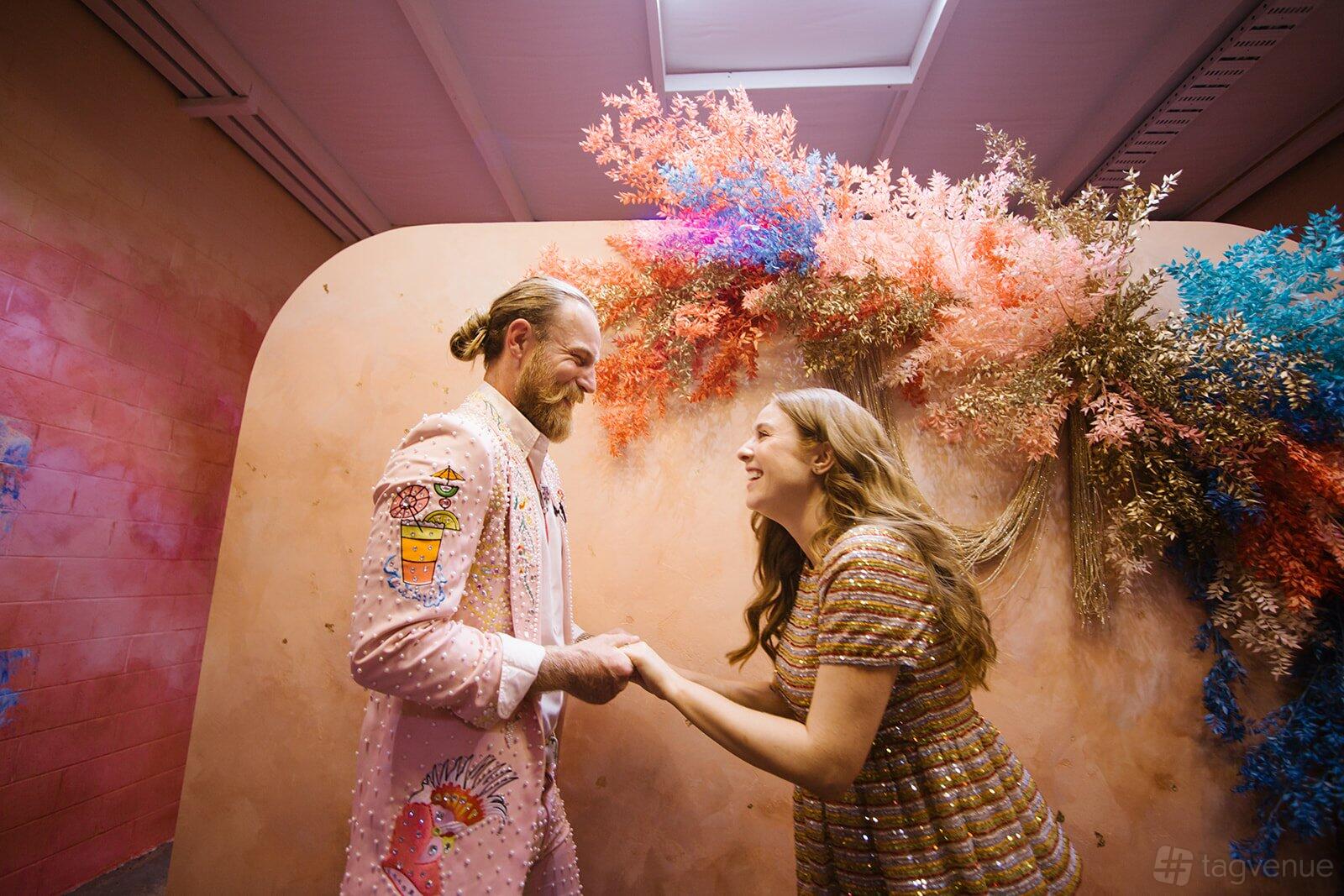 A chapel with pastel-colored dried floral arrangements and warm lighting at The Altar Electric.