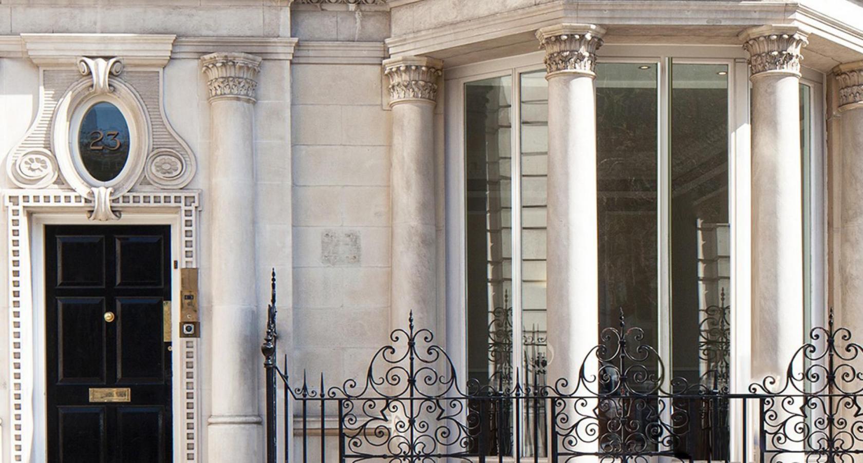 A meeting centre with grand stone pillars, large bay windows, and ornate wrought iron railings at 23-24 Berkeley Square.