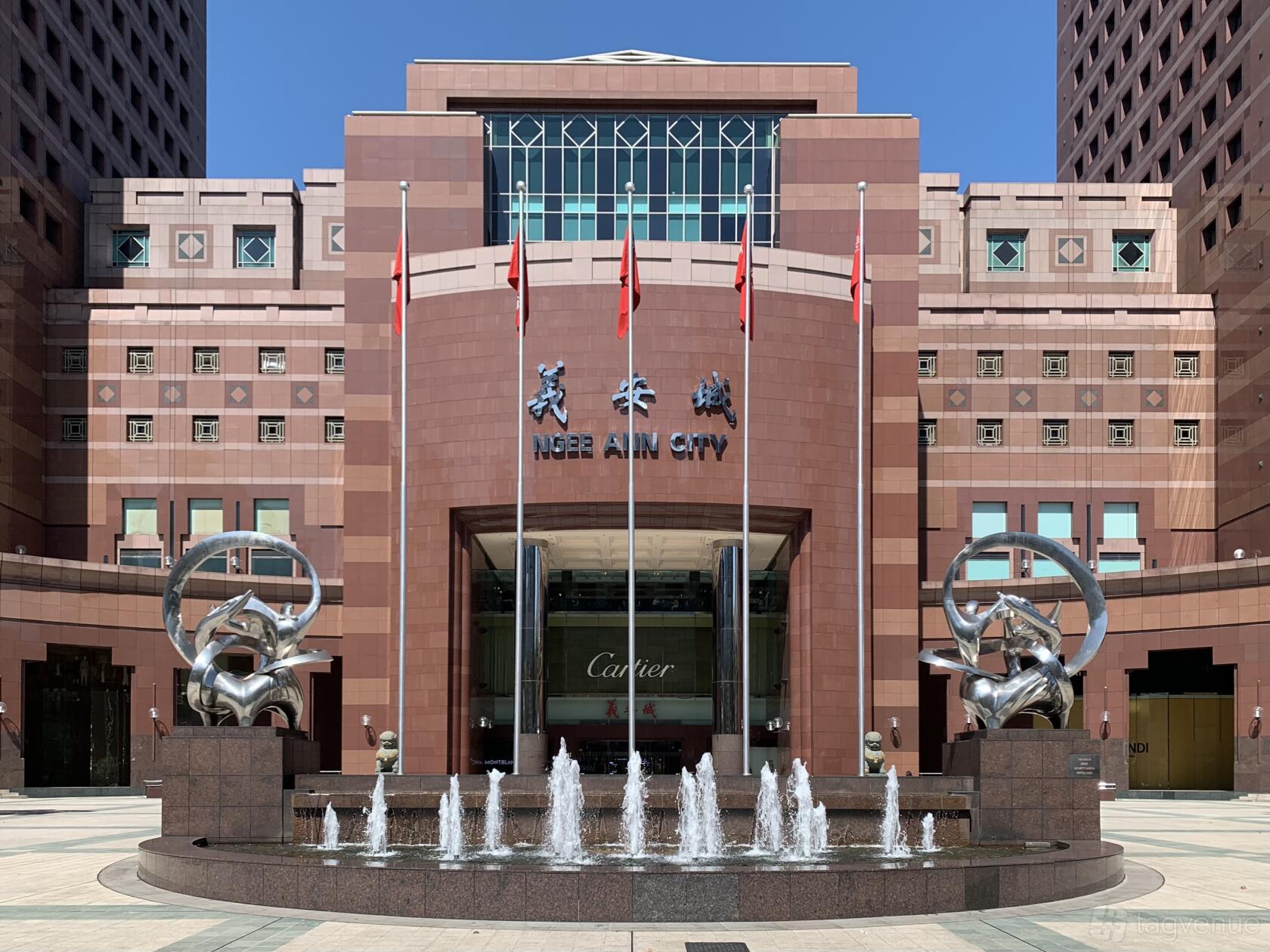 A meeting centre with a grand entrance featuring revolving doors, tall columns, and front fountains at The Great Room - Ngee Ann City.