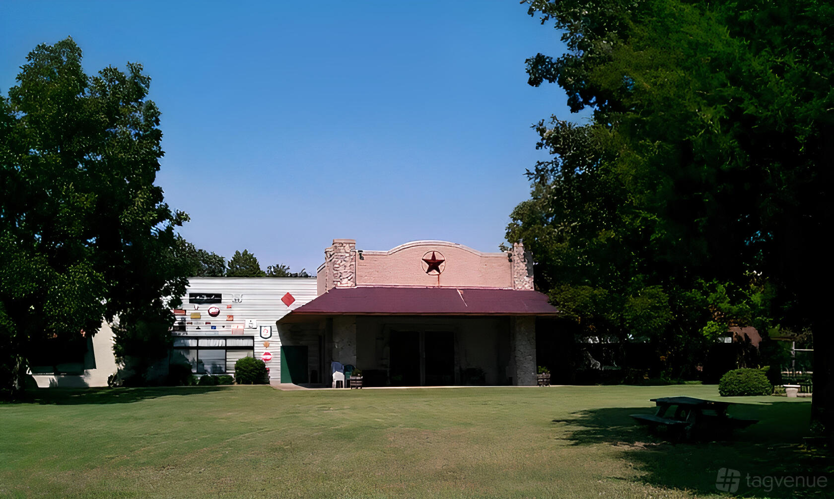 A versatile event space with a wide lawn, stone facade, and star-shaped vent at Southern Cross.