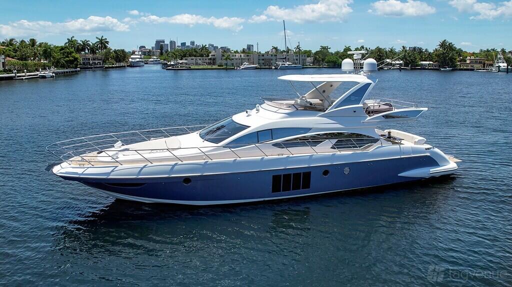 A sleek white yacht with spacious deck areas cruising on open water at Pearl Yacht Charters.