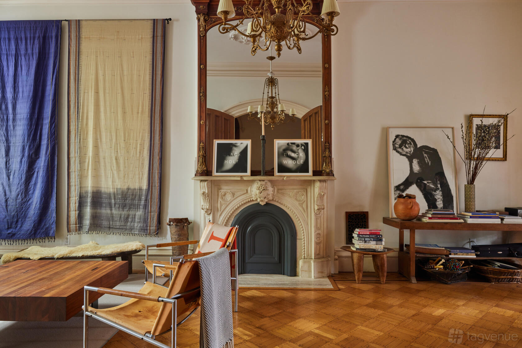 A house with a decorative fireplace, chandeliers, parquet flooring, and eclectic art at Casa Escondida.