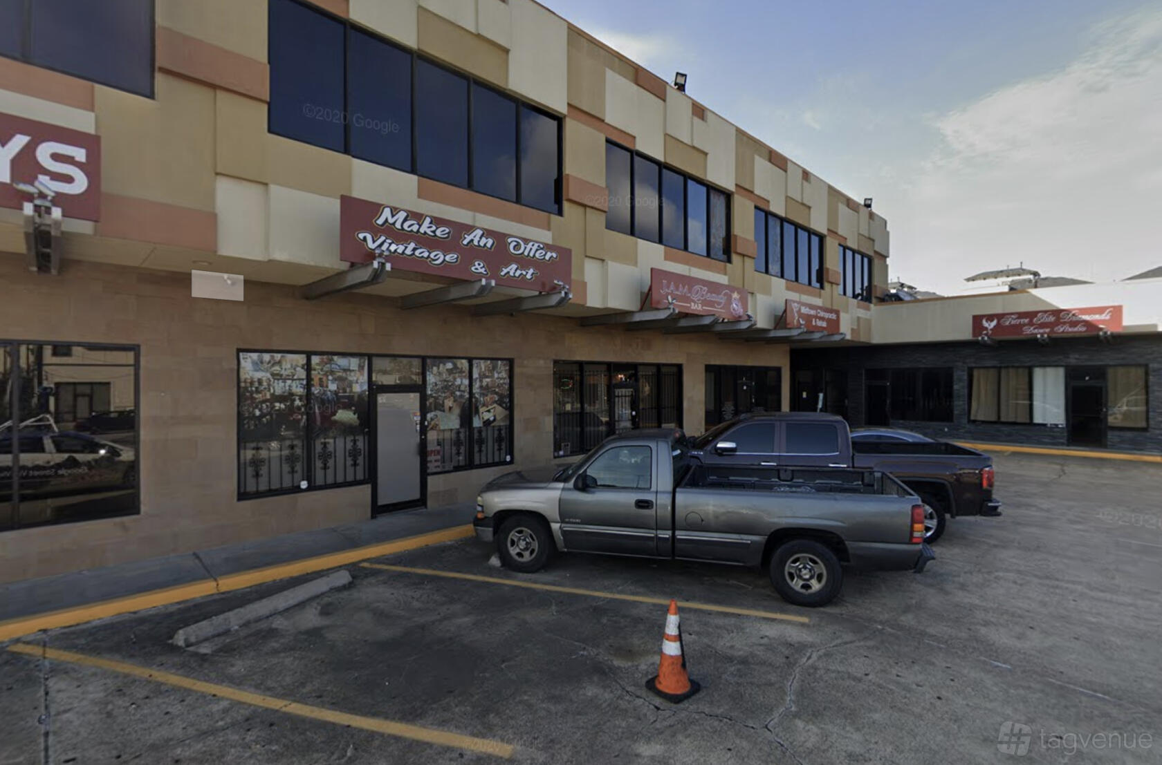 A restaurant with large windows and store signage in a shopping plaza at Emma's Kitchen.