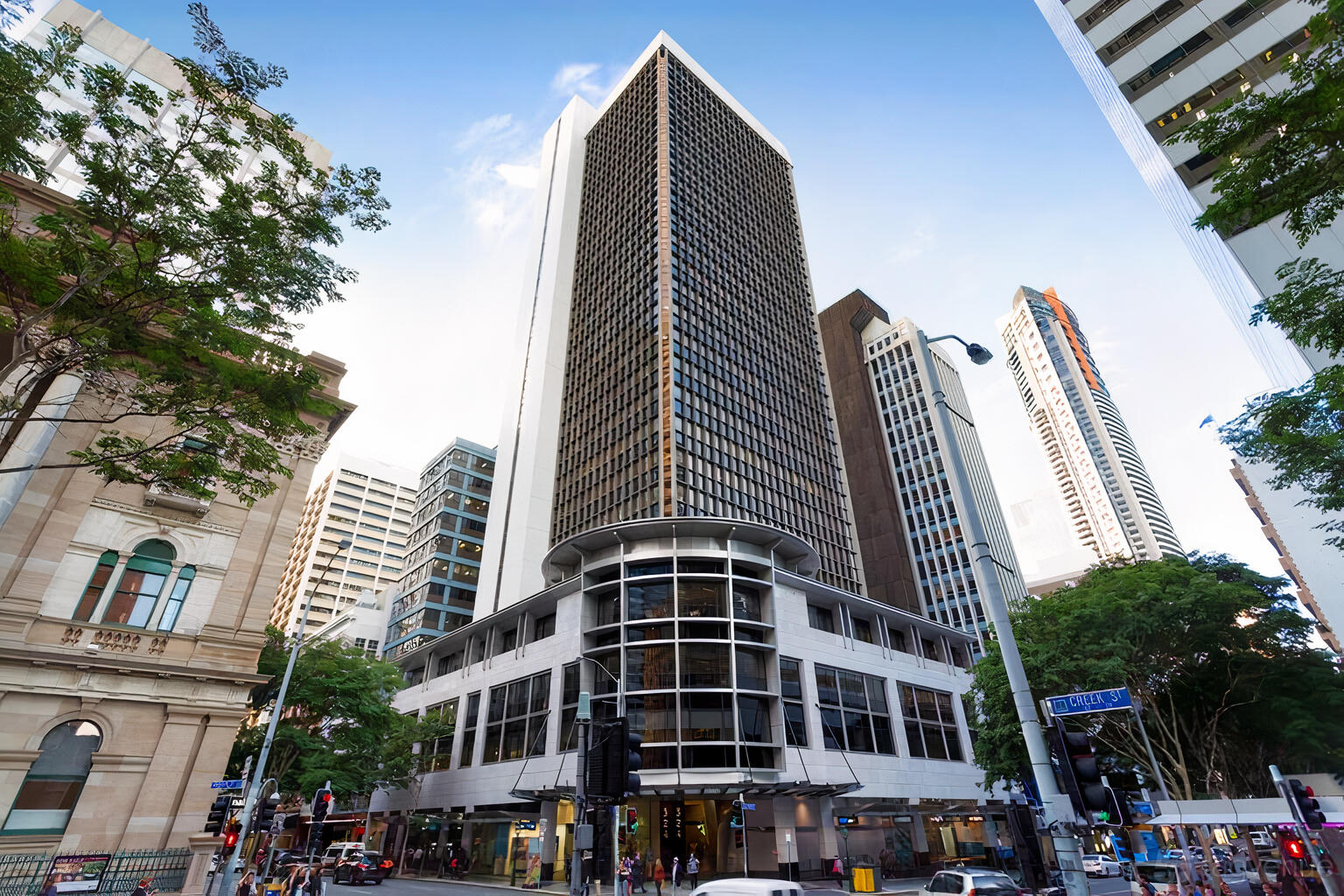 A meeting centre in a high-rise office building with a rounded glass facade at @Workspaces Queen Street.