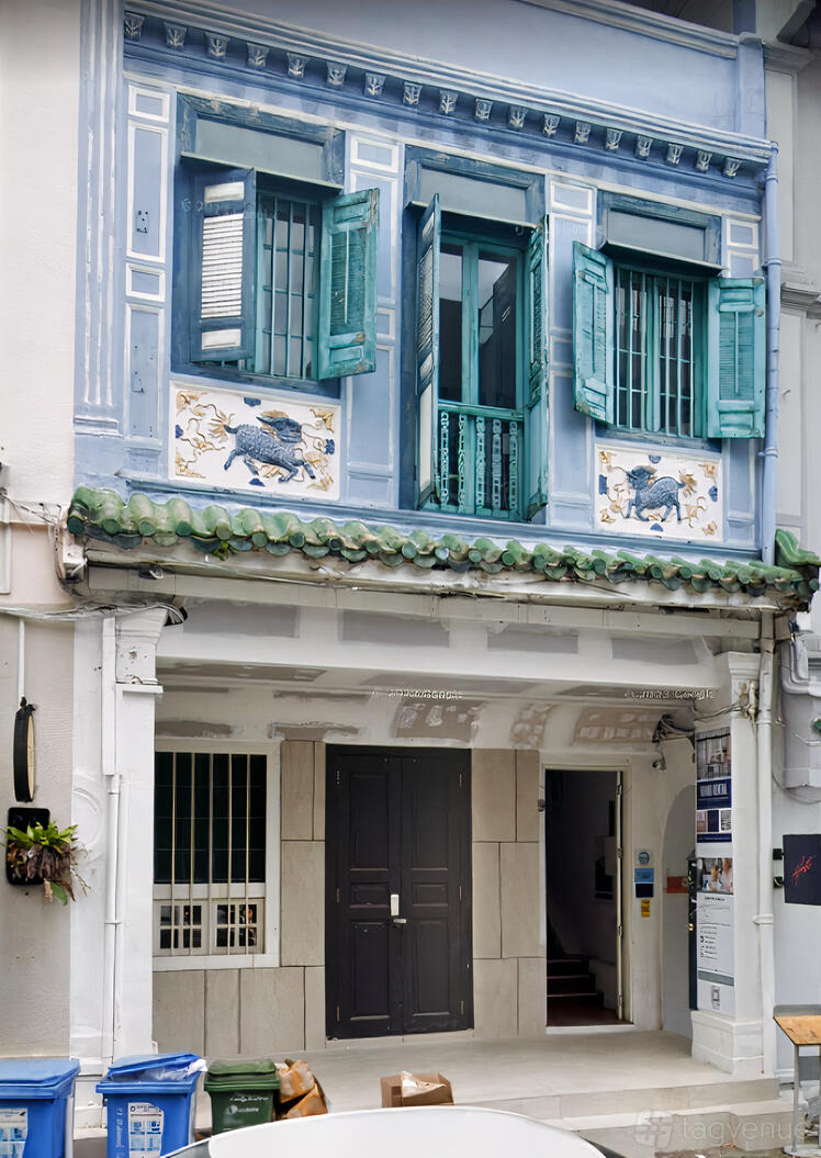 A versatile event space with traditional blue window shutters and decorative tiled panels at Host Events Pte Ltd.