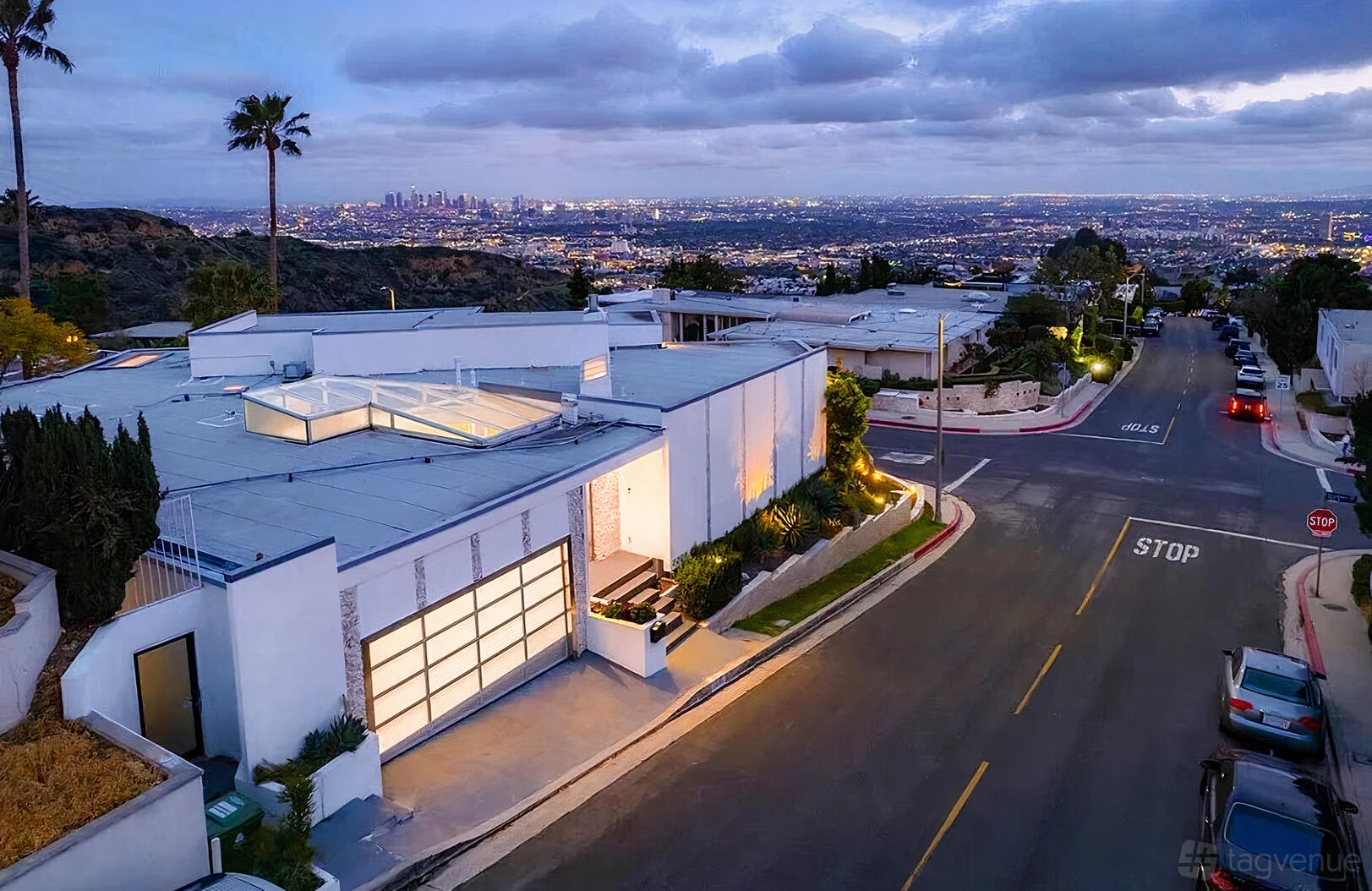 An apartment with a glass garage door, outdoor lighting, and downtown skyline views at Beautiful Villa with Downtown Views.