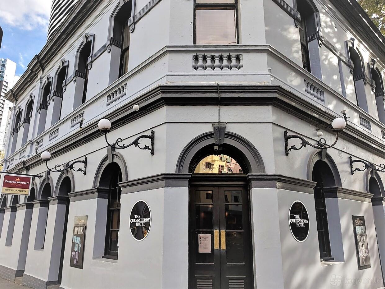 A historic hotel with arched windows, white facade, and ornate black trim at Queensberry Hotel.