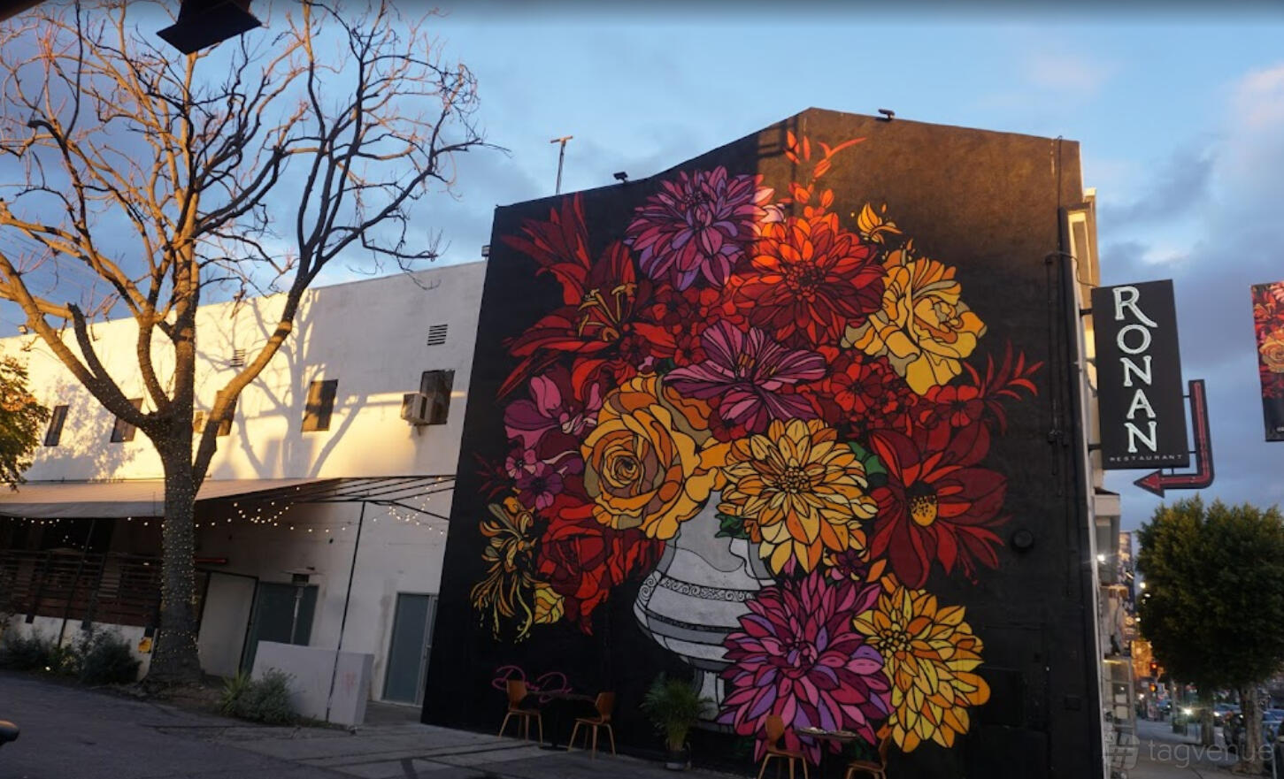 A restaurant with a vibrant floral mural painted on the exterior wall at Ronan.