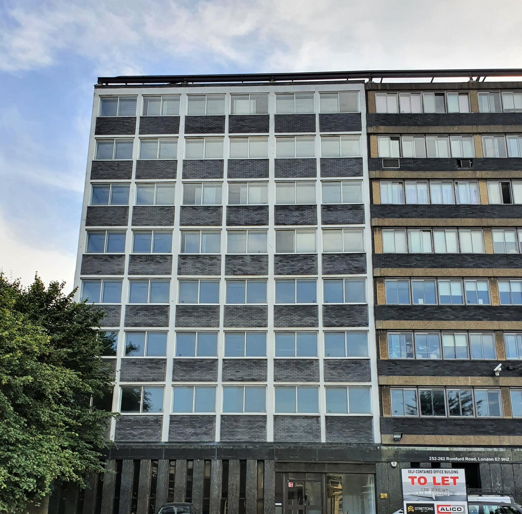A meeting centre with a modern glass and brick facade and rows of large windows at Avicenna House.